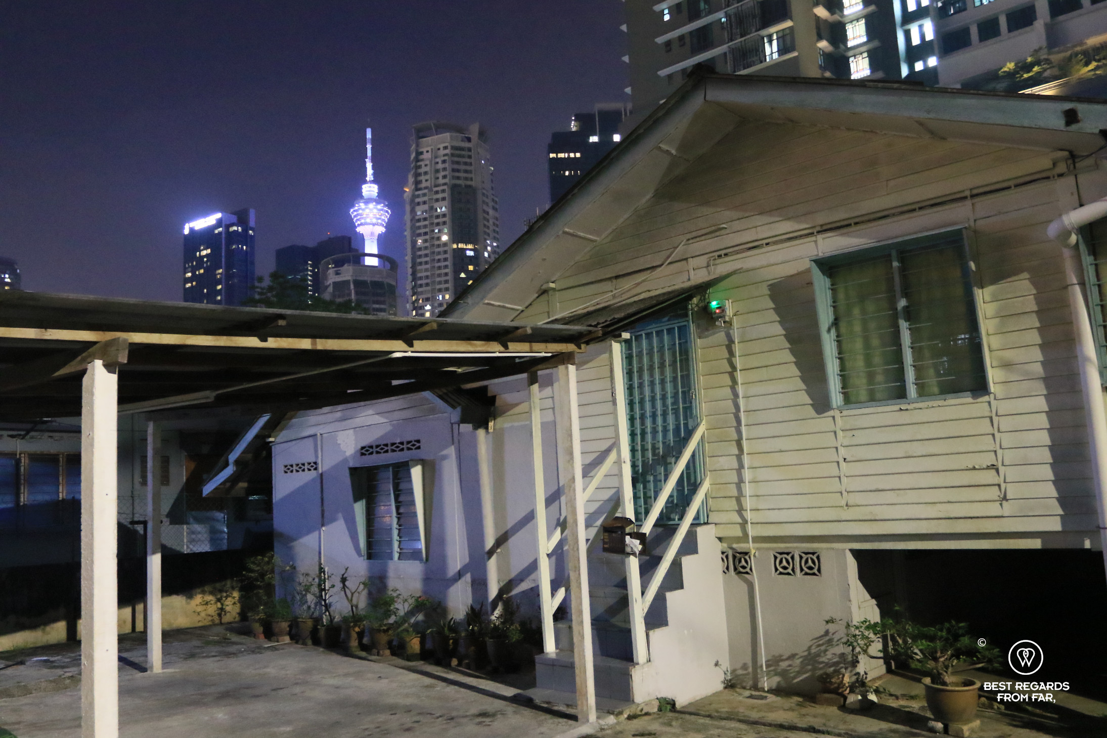 Old house contrasting with skyscrapers, Kampung Baru, Kuala Lumpur, Malaysia