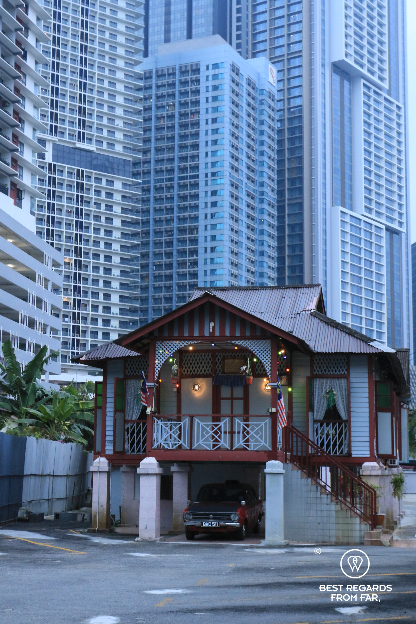 Old house contrasting with skyscrapers, Kampung Baru, Kuala Lumpur, Malaysia
