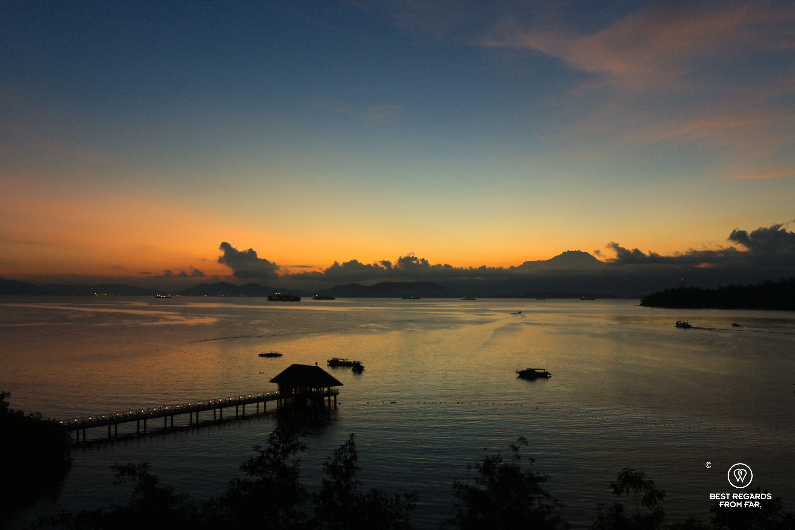 The moment before sunrise on a calm sea.
