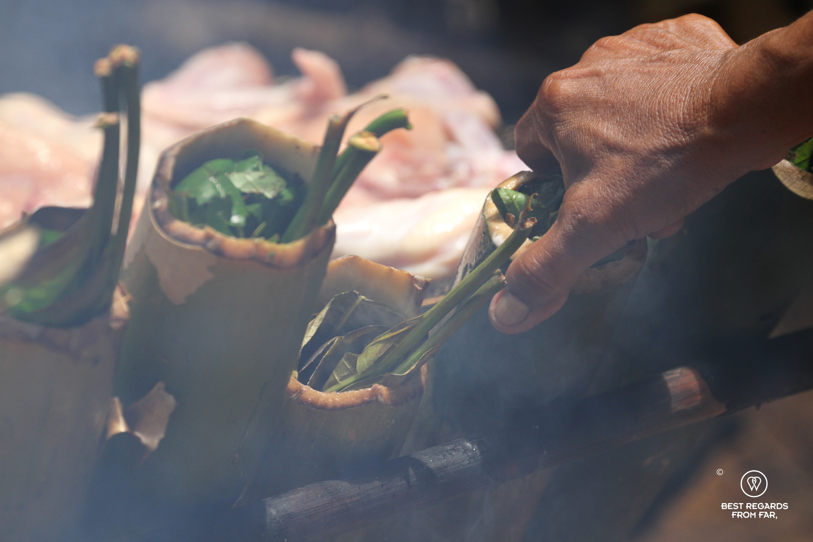 Vegetables being cooked in bamboo.