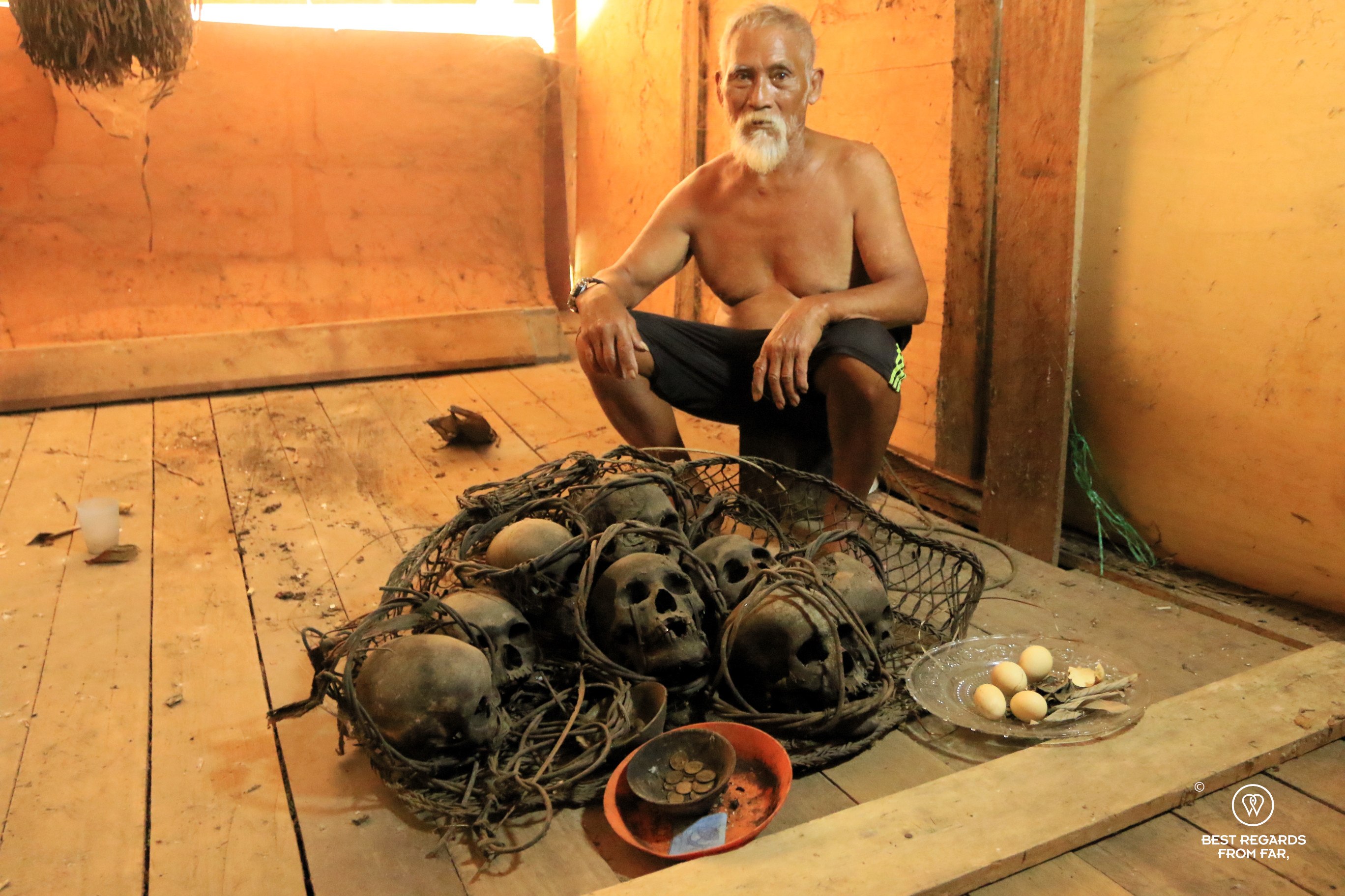 Human skulls presented by a proud Iban member with money and eggs as an offering for their souls.