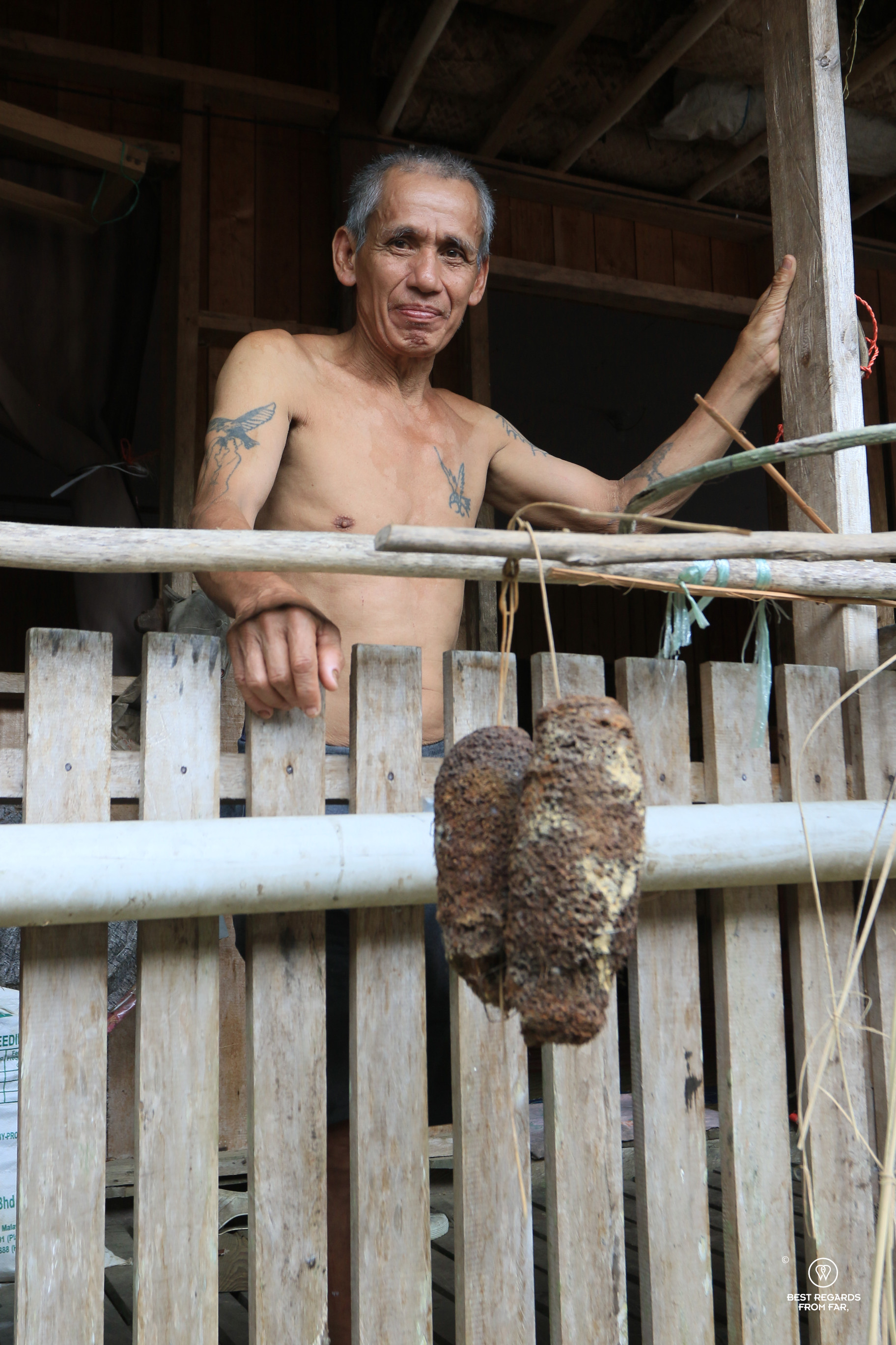 Bare-chested Iban man in longhouse in Nanga Sumpa-Borneo with tattoos.