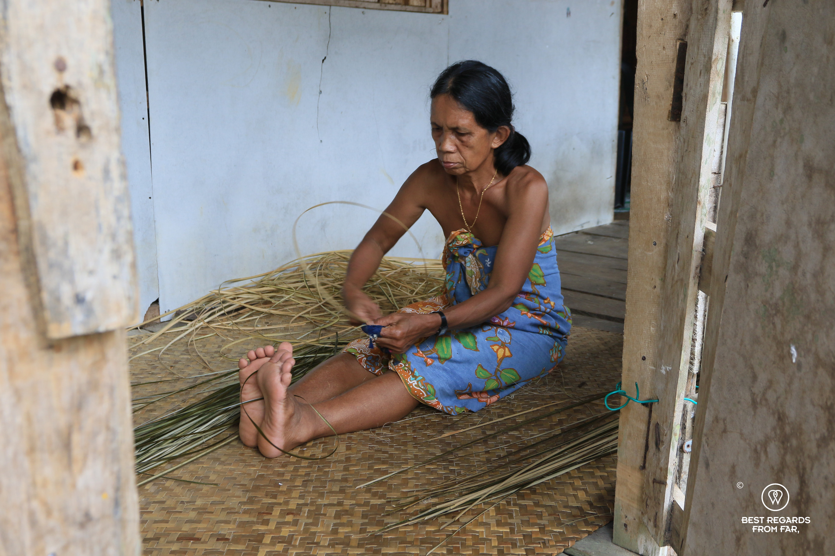 Iban woman weaving in longhouse in Nanga Sumpa-Borneo.