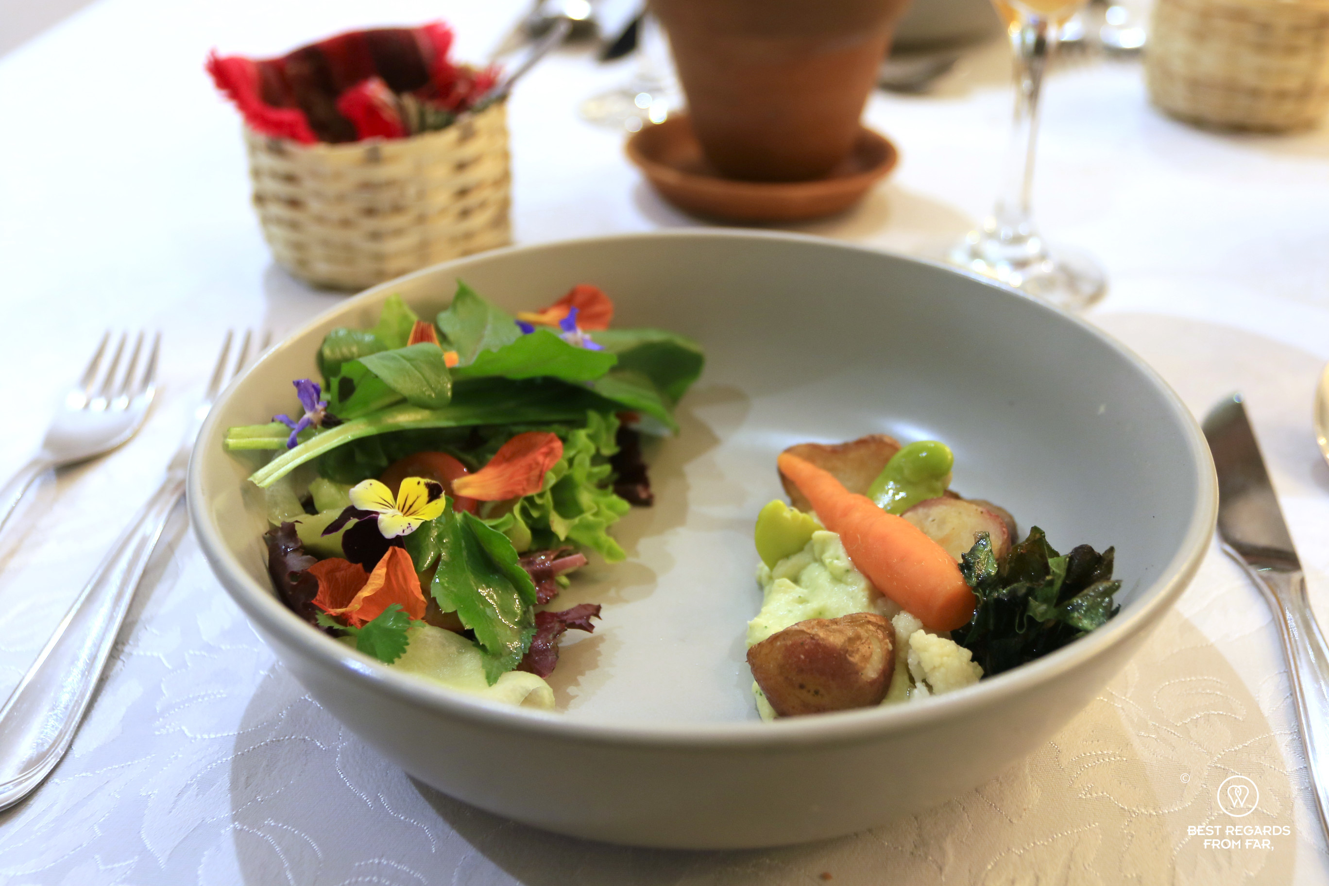 Seasonal salad topped with colorful edible flowers at El Solar Restaurant in Sucre, Bolivia.