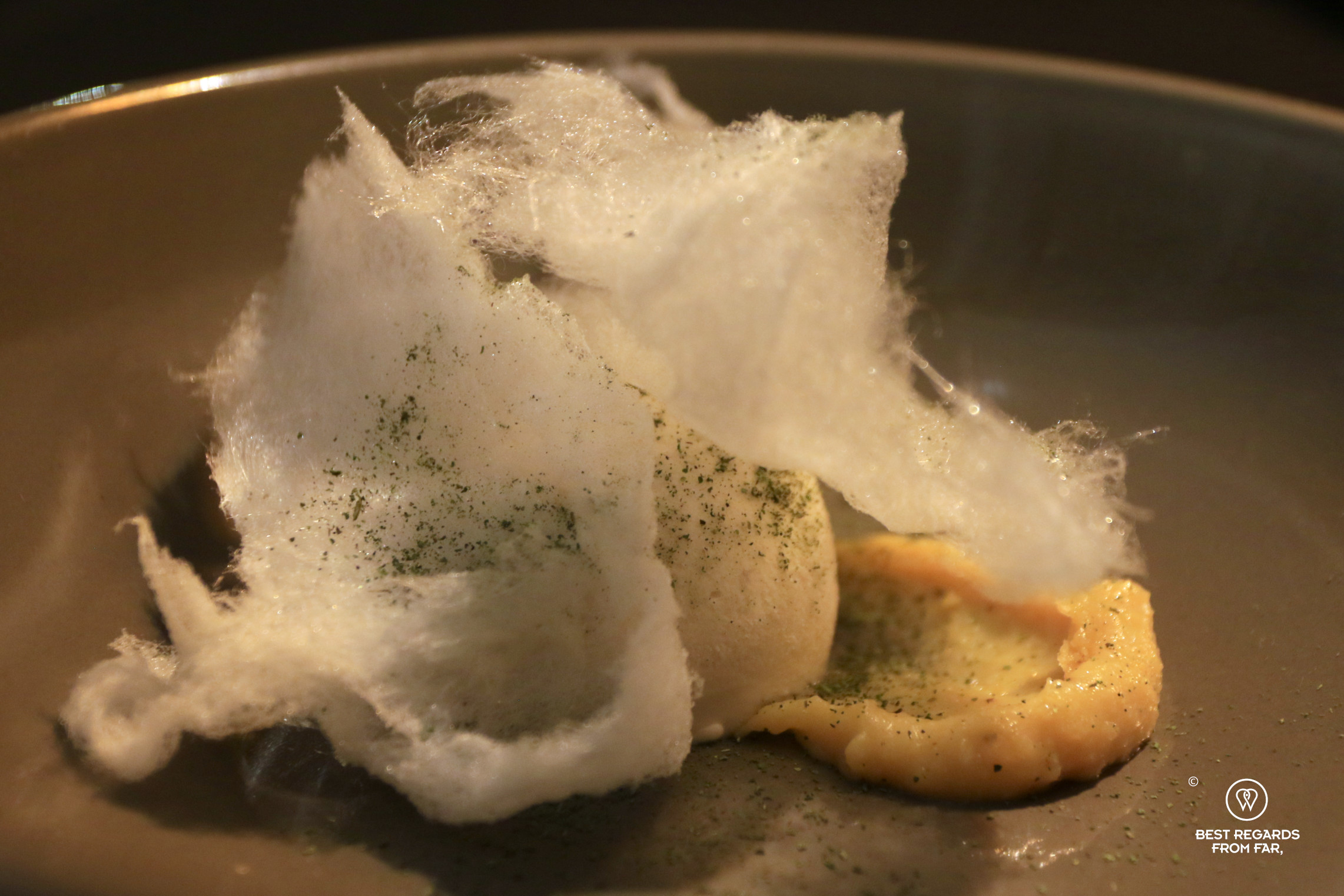 Chirimoya ice cream, fried banana, and cotton candy dessert at Proyecto Nativa Restaurant in Sucre, Bolivia.