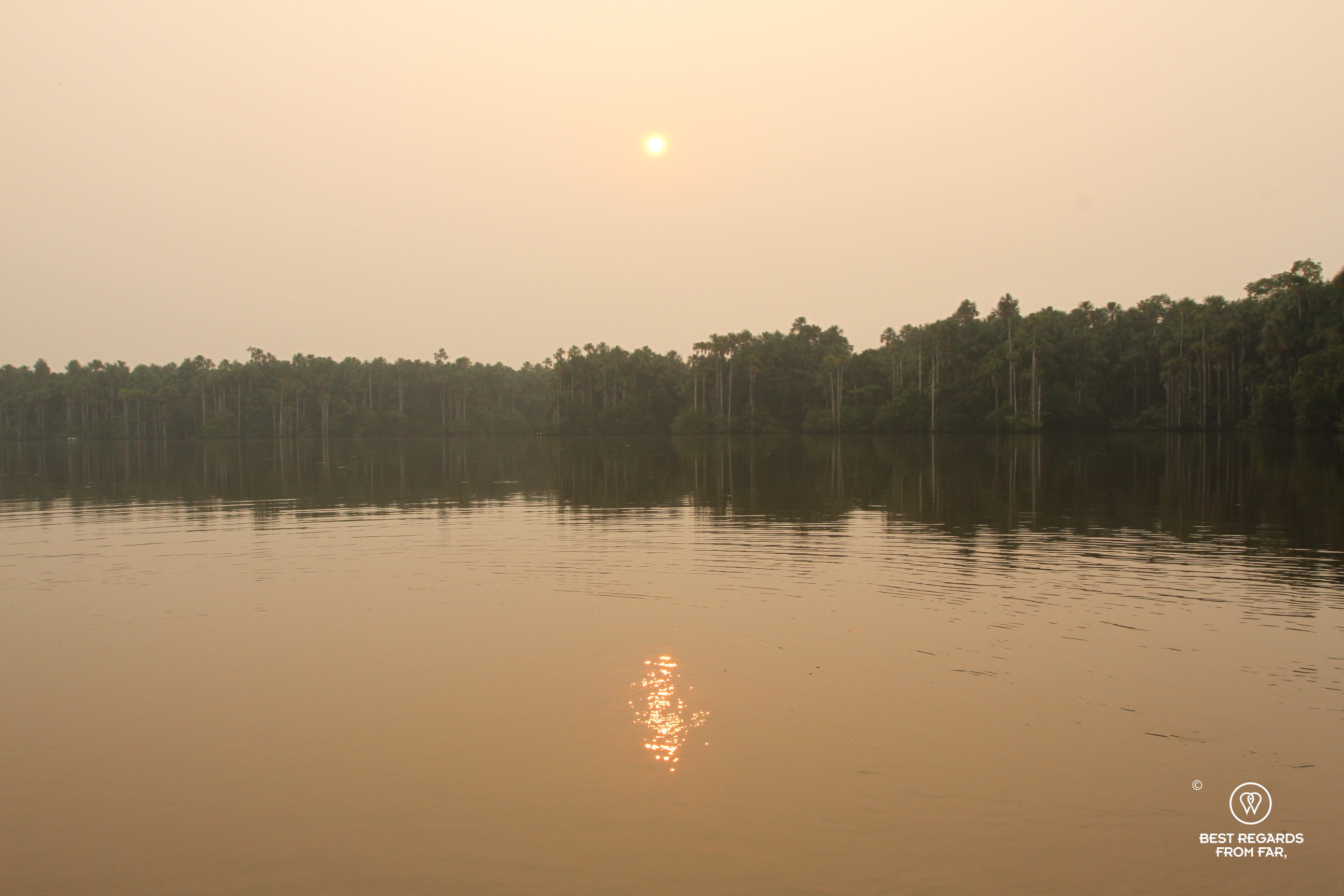 Sunset on the Sandoval Lake filetered by the smoke of the Amazon forest fires.