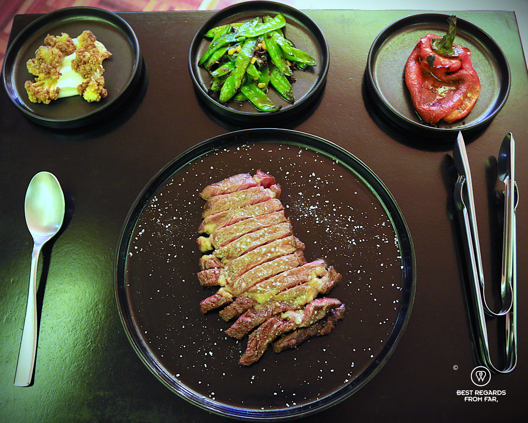 Steak and vegetable as sides at Ancestral restaurant in La Paz.