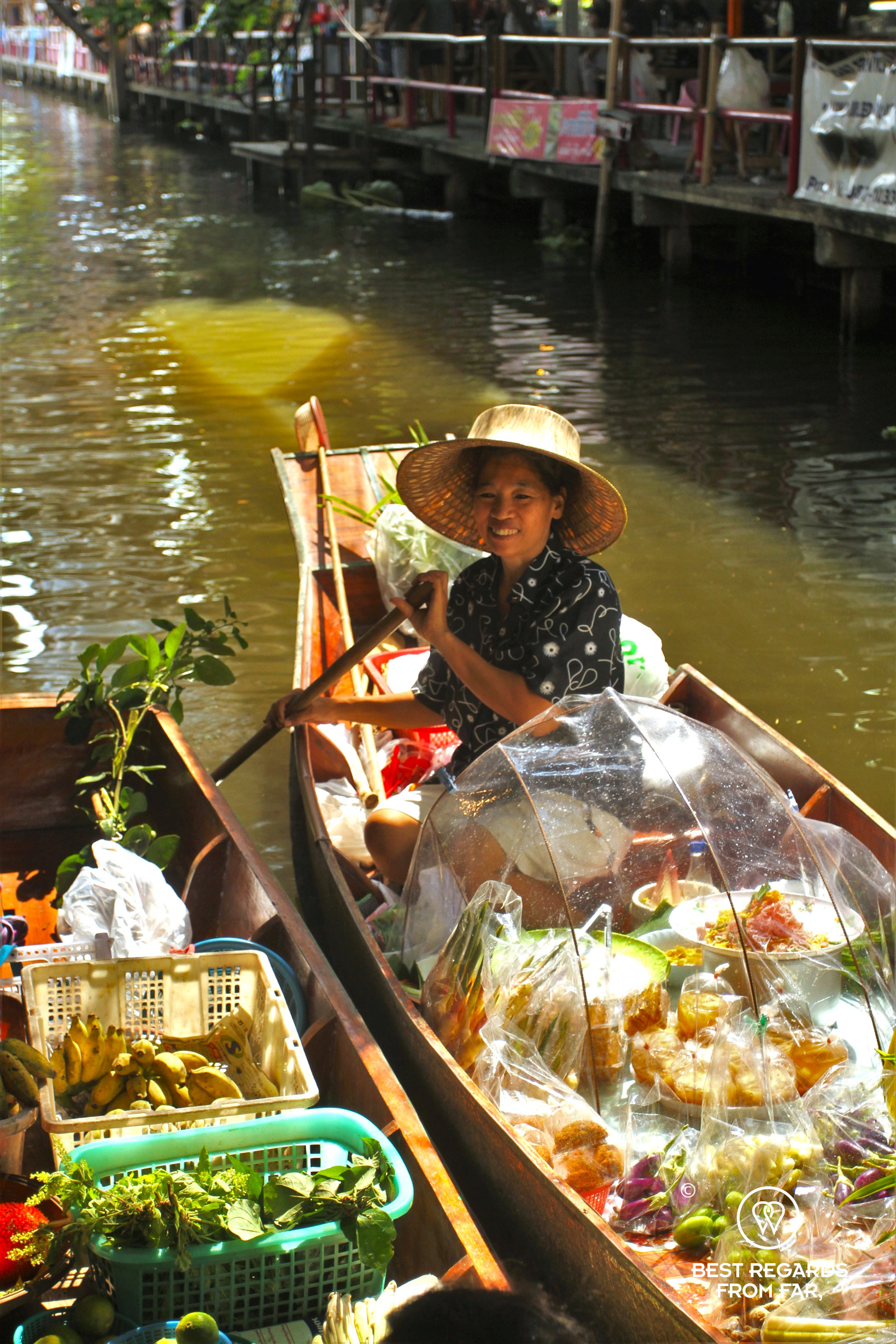 Woman smiling on a boat at the Klong Lat Mayom floating market, Bangkok.