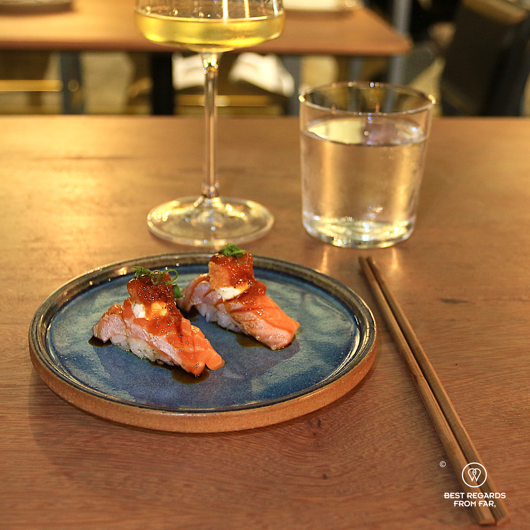Salmon nigiri with a glass of white wine at Tomo restaurant in Lima, Miraflores.