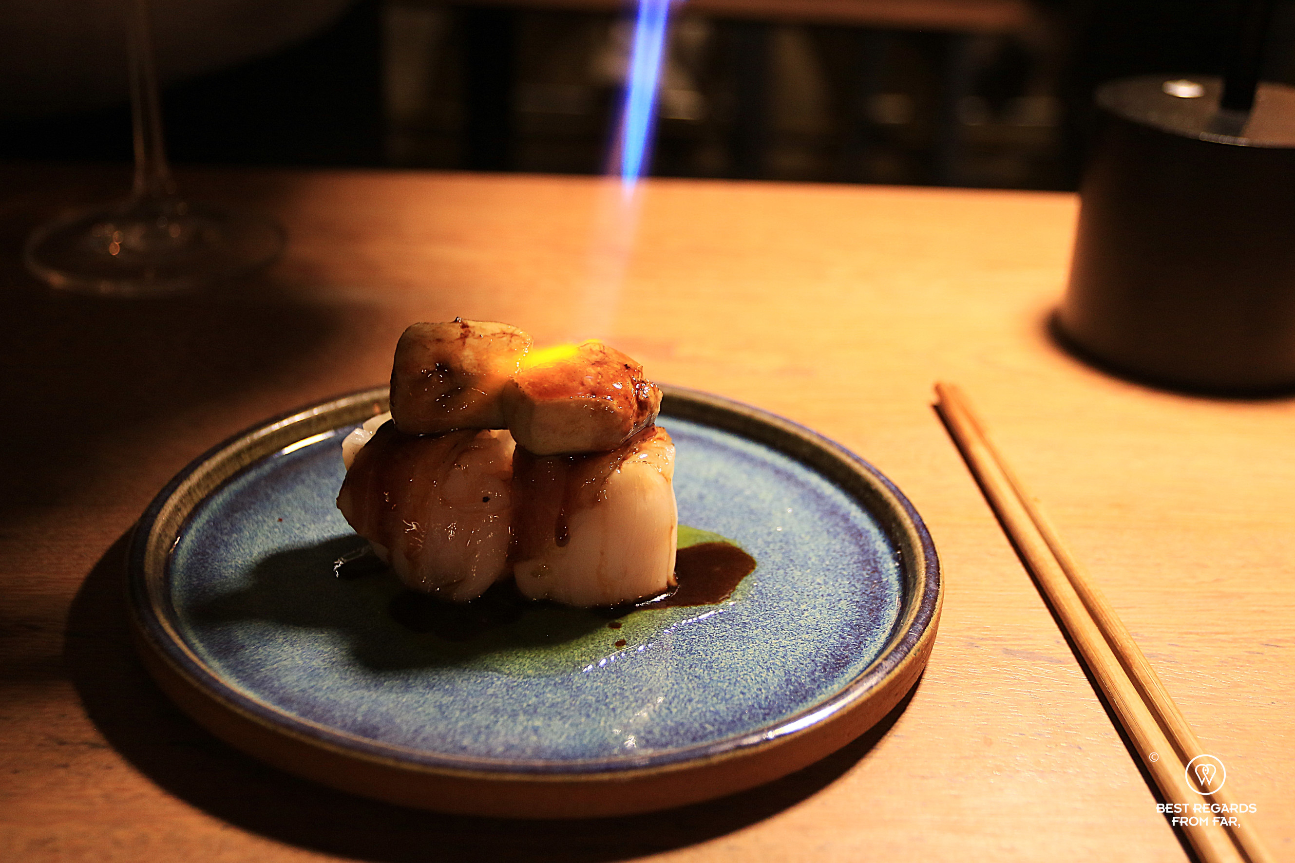 Foie gras flamed at the table topping off scallops and seared duck at Tomo restaurant in Lima, Miraflores.