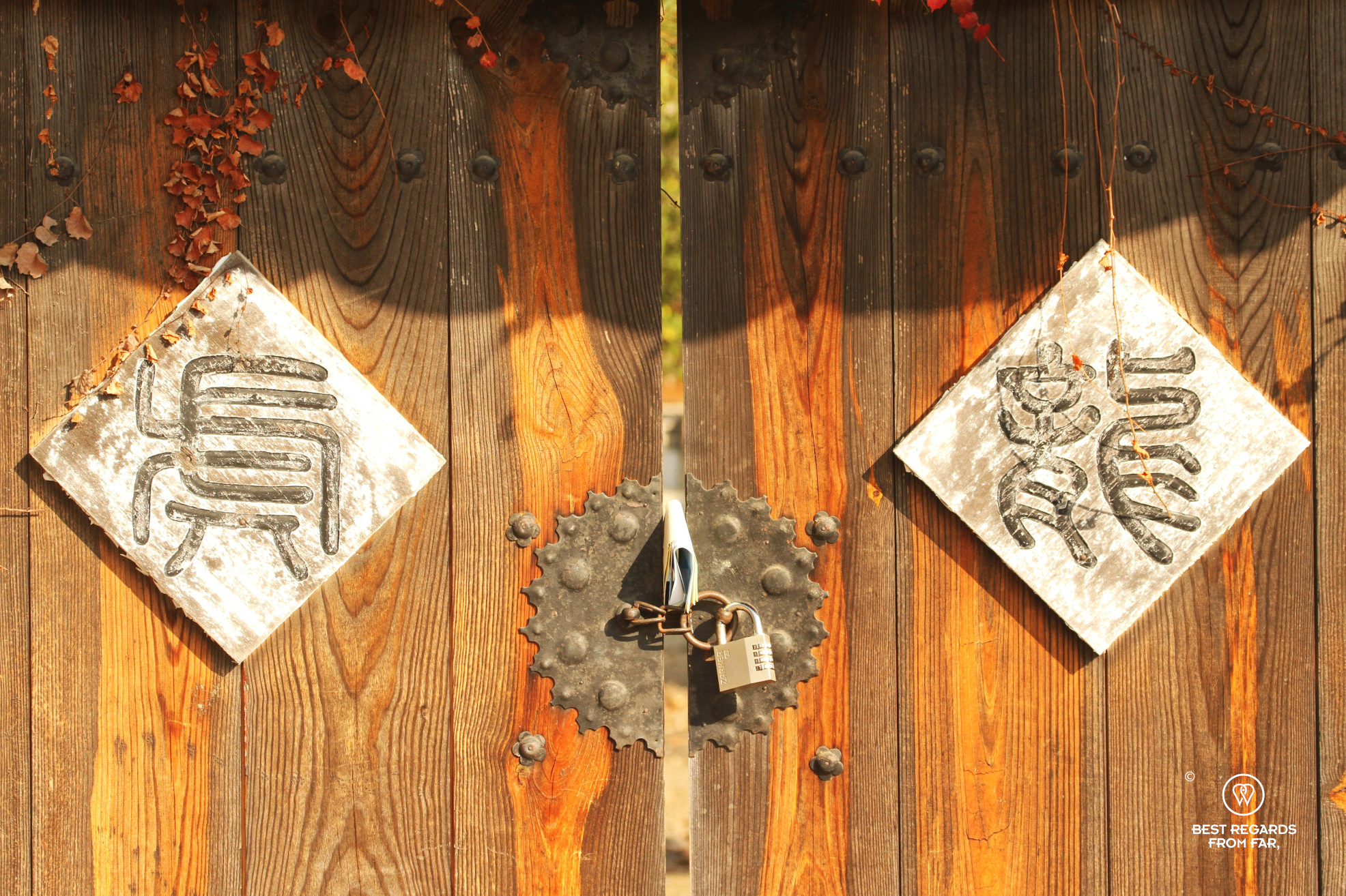 Detail of a wooden door with the tiger and dragon Chinese characters in Hahoe.