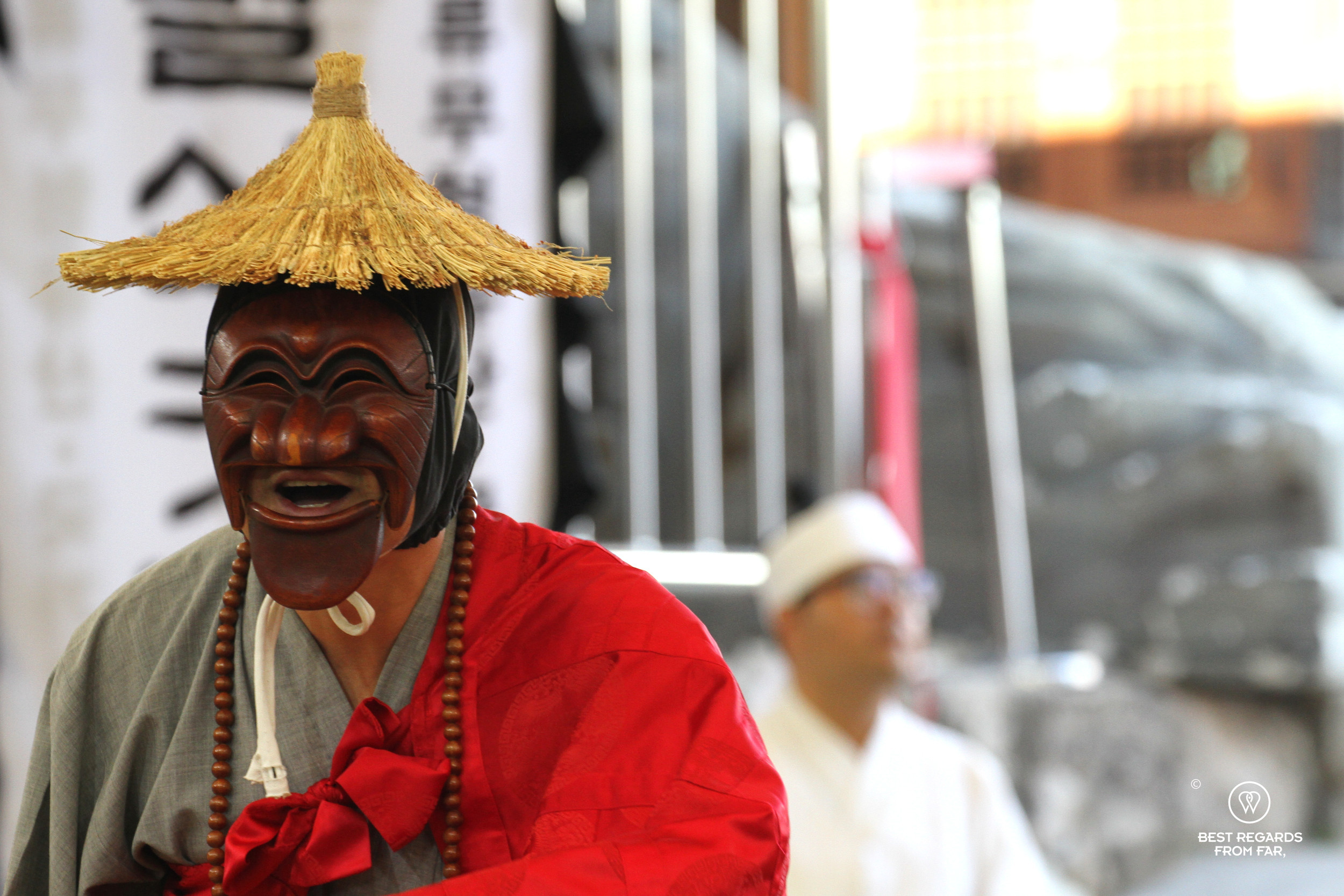 Close up of the monk dancing the Hahoe Mask Dance and wearing his traditional wooden mask.