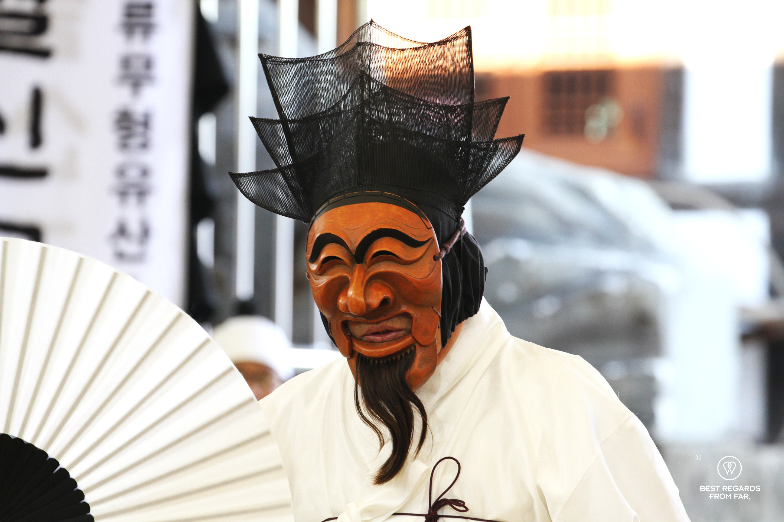 Close up of the noble dancing the Hahoe Mask Dance and wearing his traditional wooden mask.