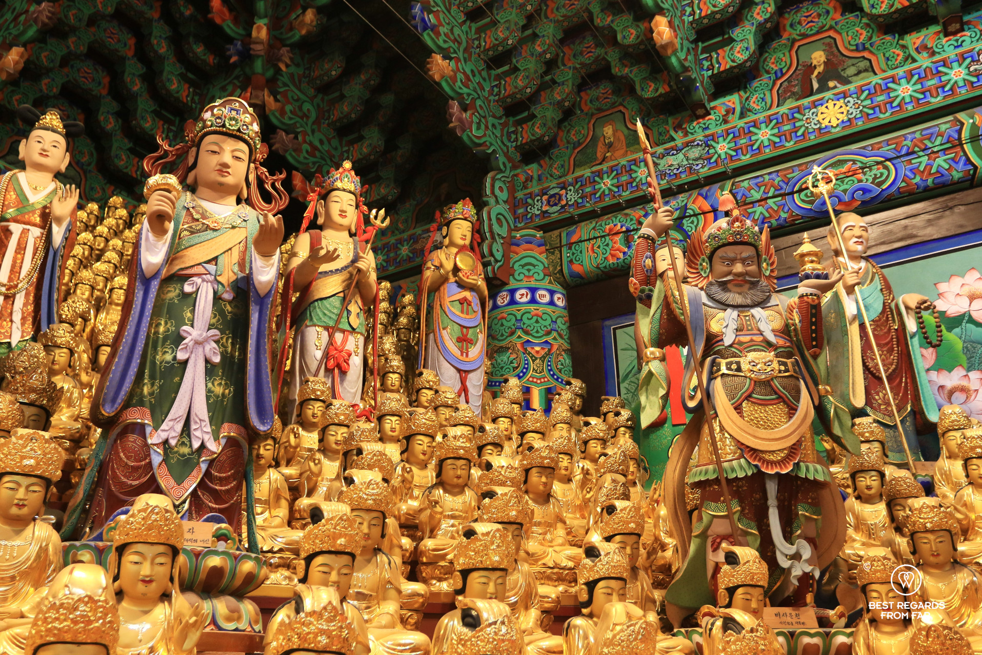 Golden and colorful statues in the Prayer Hall, Naksansa temple.