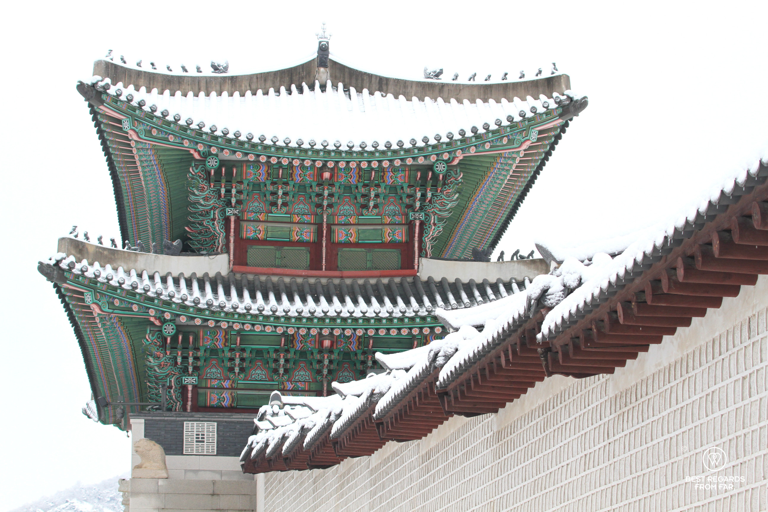 Gate and wall covered in snow at the Gyeongbokgung Palace in Seoul.