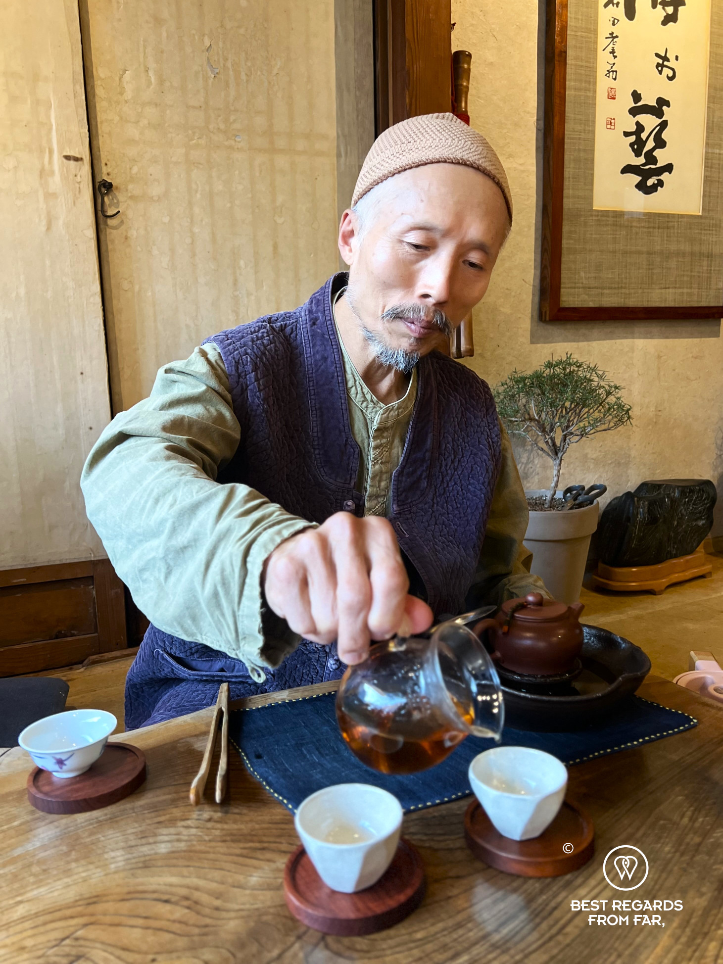 Tea master Gi Jung Hwang in traditional Korean attire serving tea at Gyodong Tea Garden in Jeonju.
