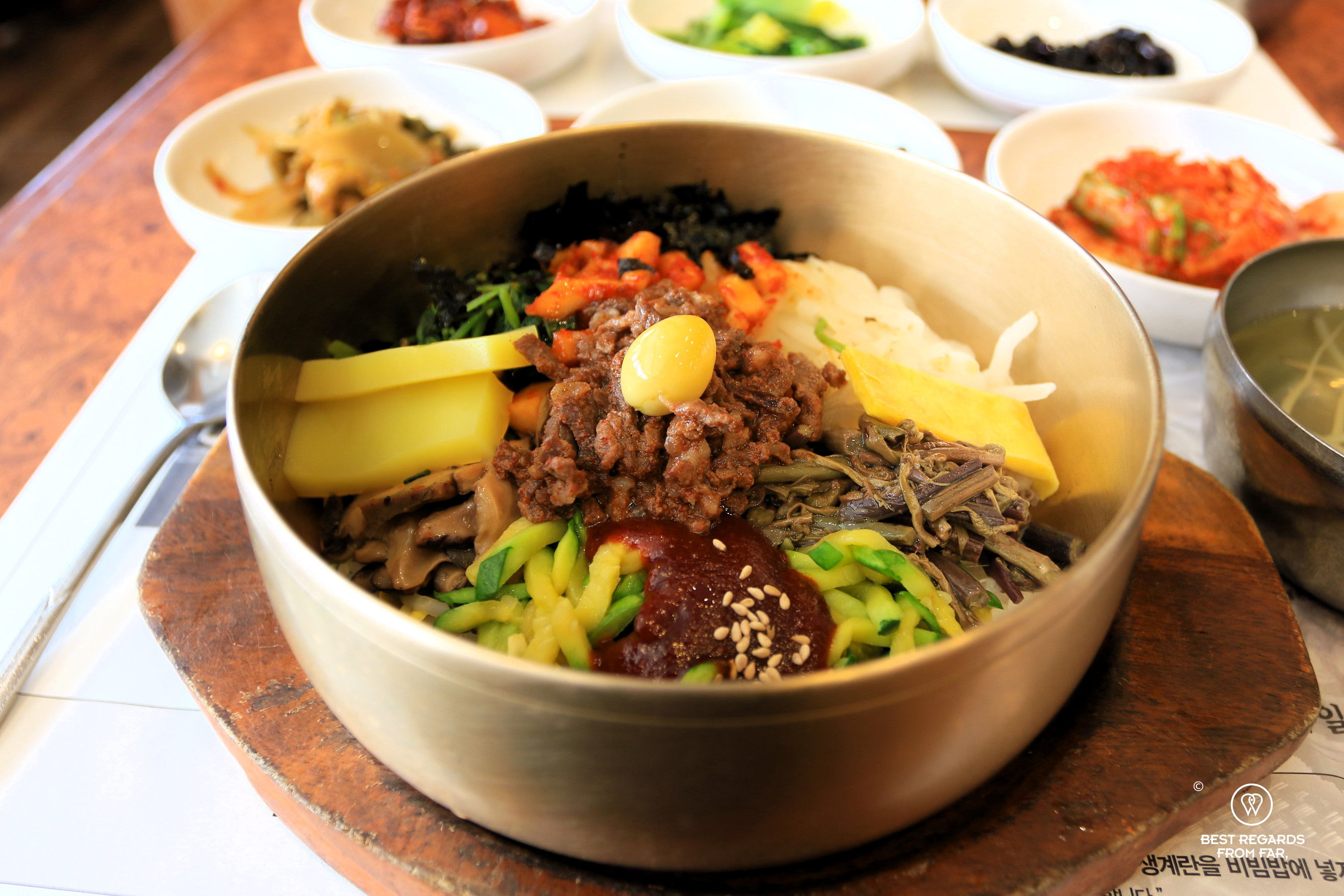 Bibimbap in a brass bowl with sides at the Hankookjib restaurant in Jeonju.