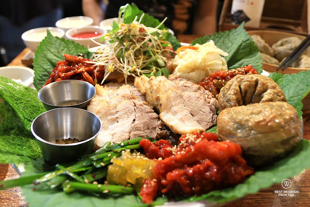 Party platter with dumplings, pork and sides at Jalppajin Memil restaurant in Seoul.
