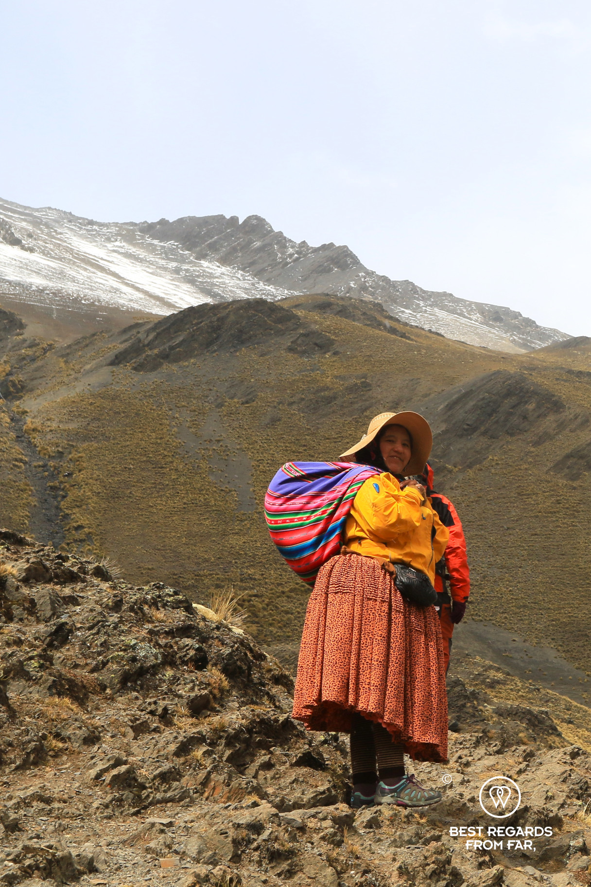 Cholita Vicky hiking to Condoriri base camp in traditional clothes.