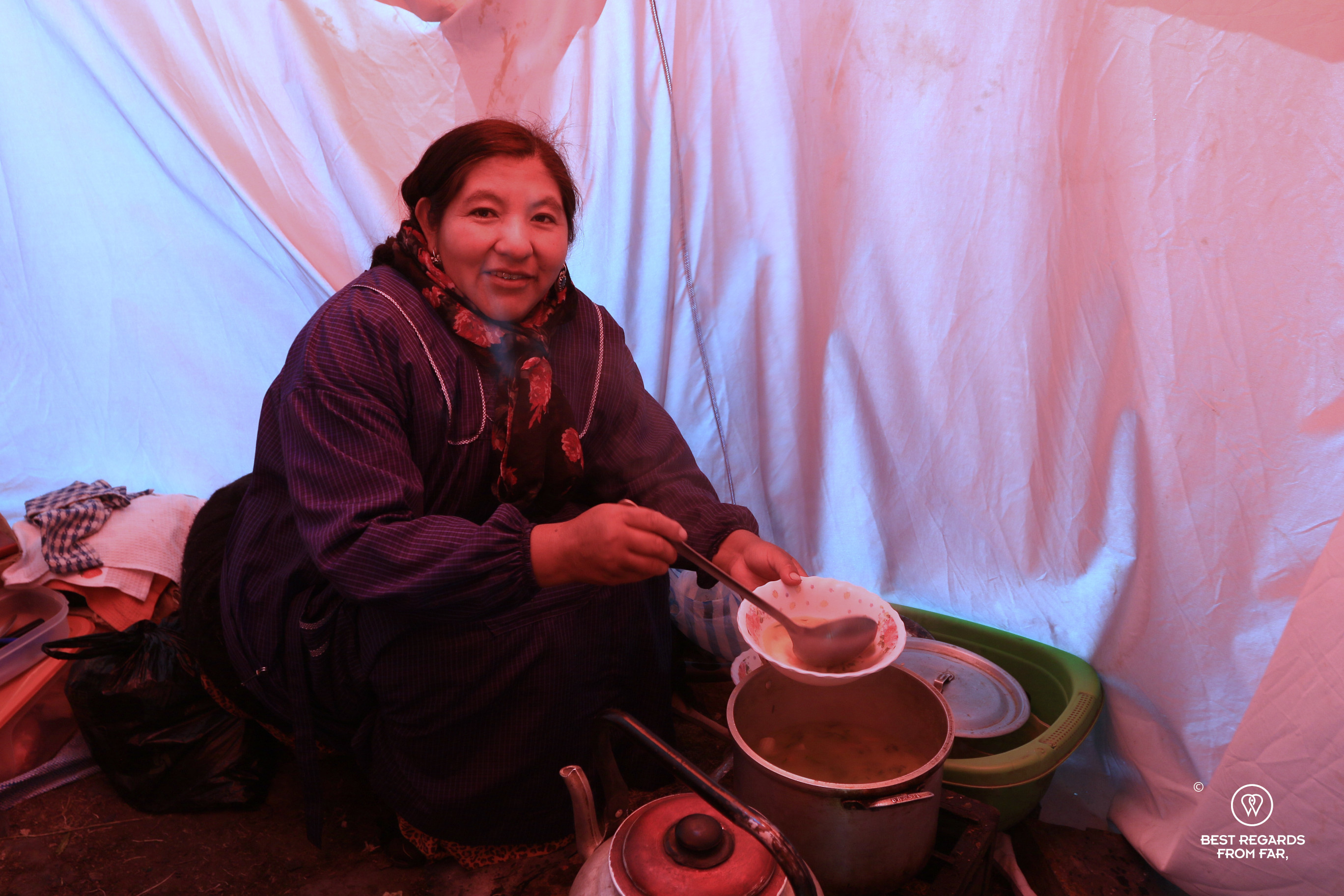 Cholita Vicky serving hot soup in the cooking tent at Condoriri base camp.