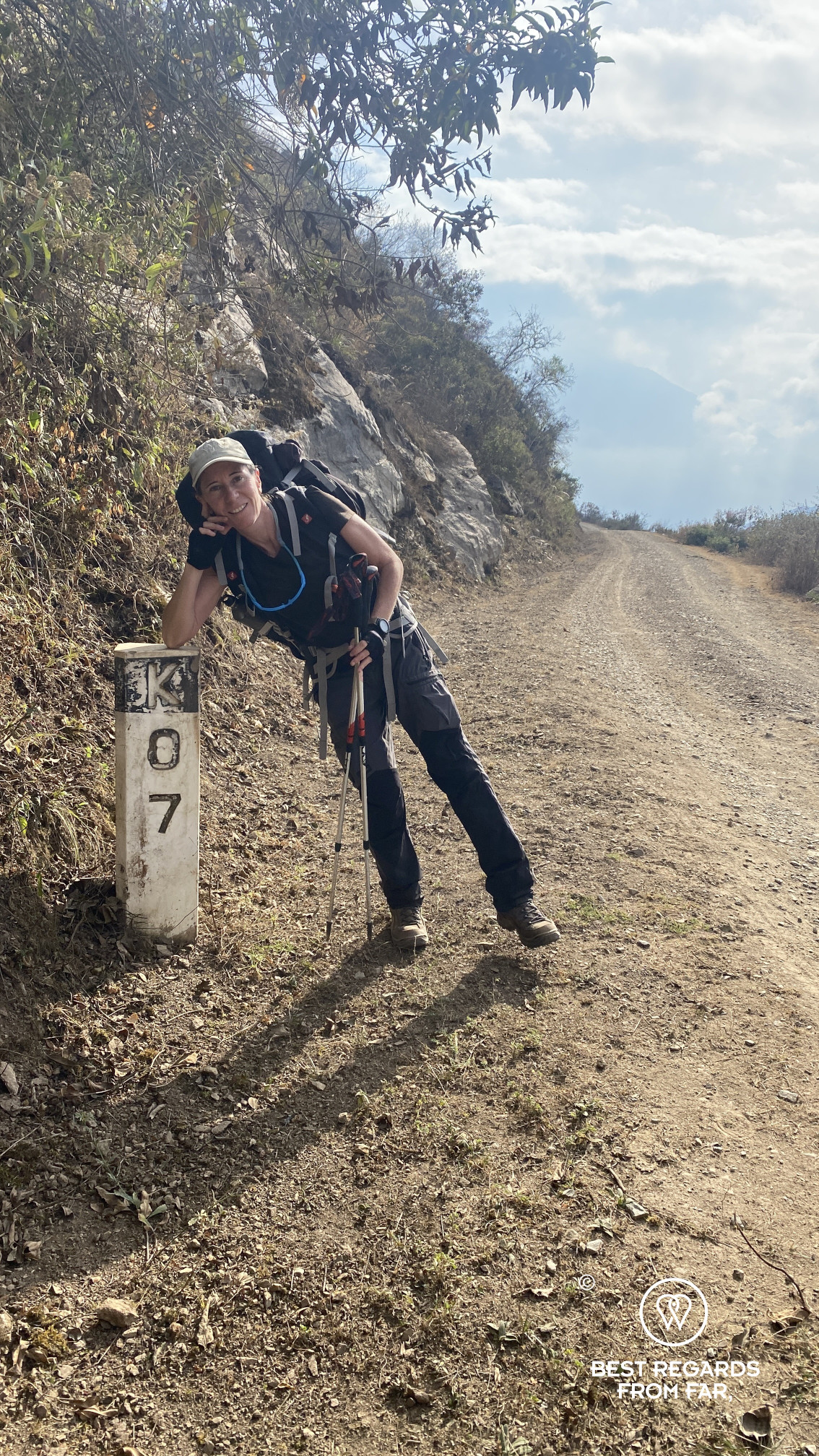 Author Claire Lessiau by trail marker 7 along the trail to Choquequirao.