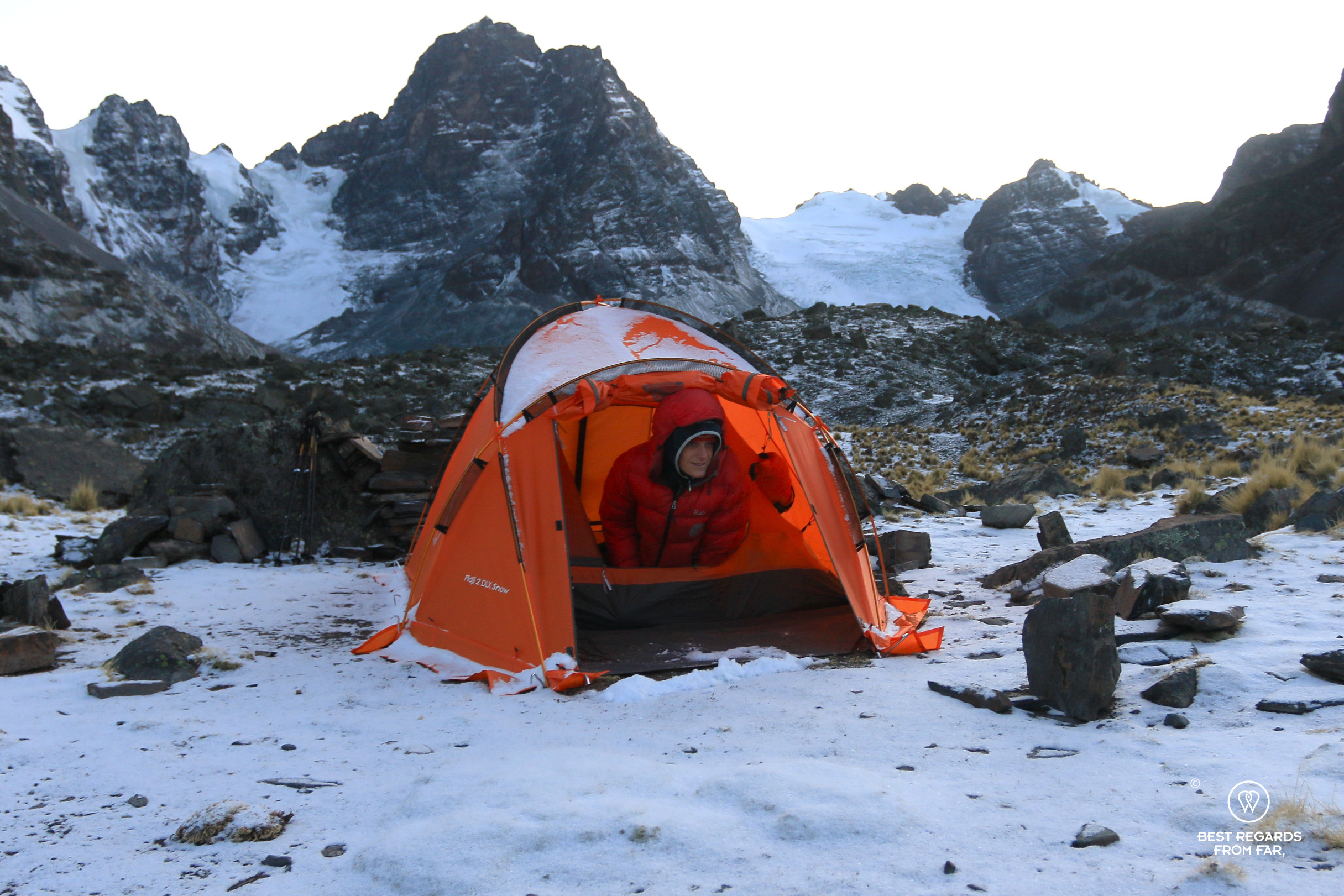 Orange Freetime Outdoor tent in the snow at the Condoriri Camp.