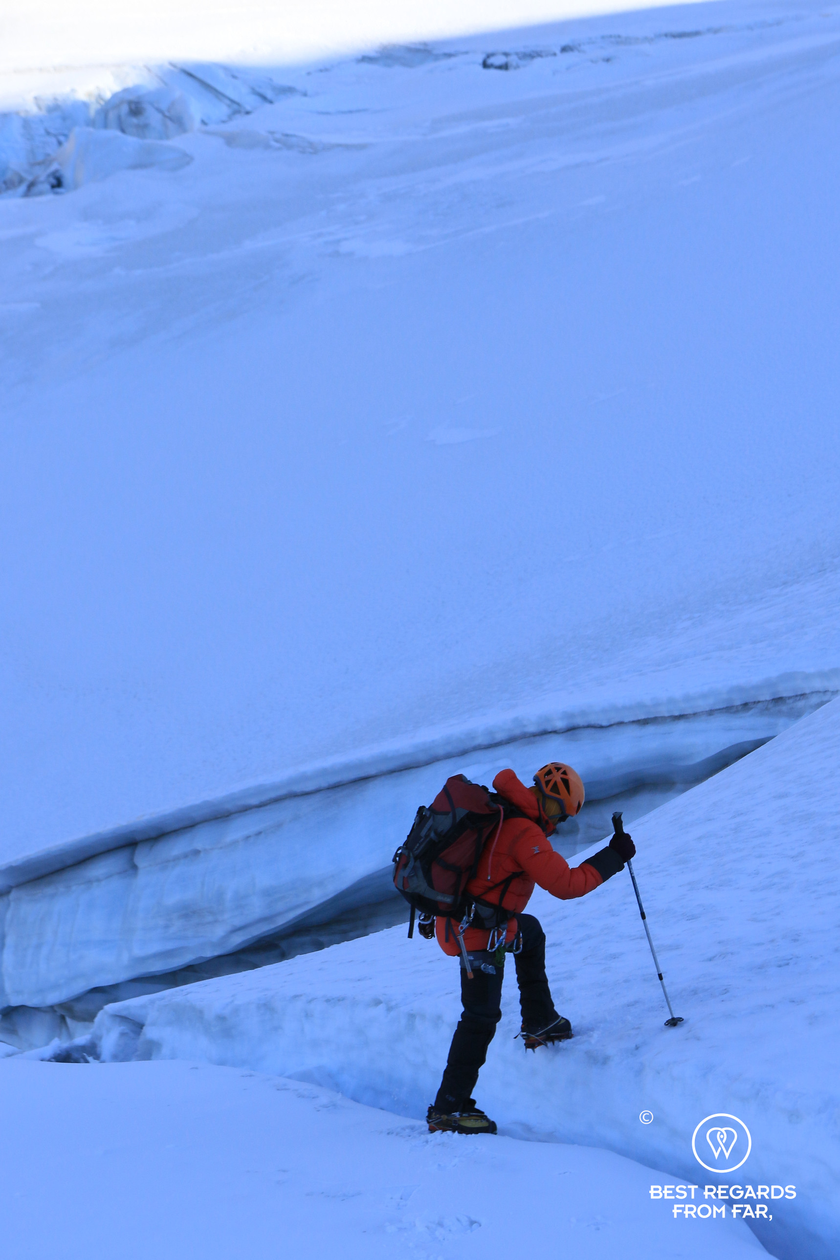 High-mountain guide Nolberto Soliz passing a crevasse on the glacier of Tarija Peak.