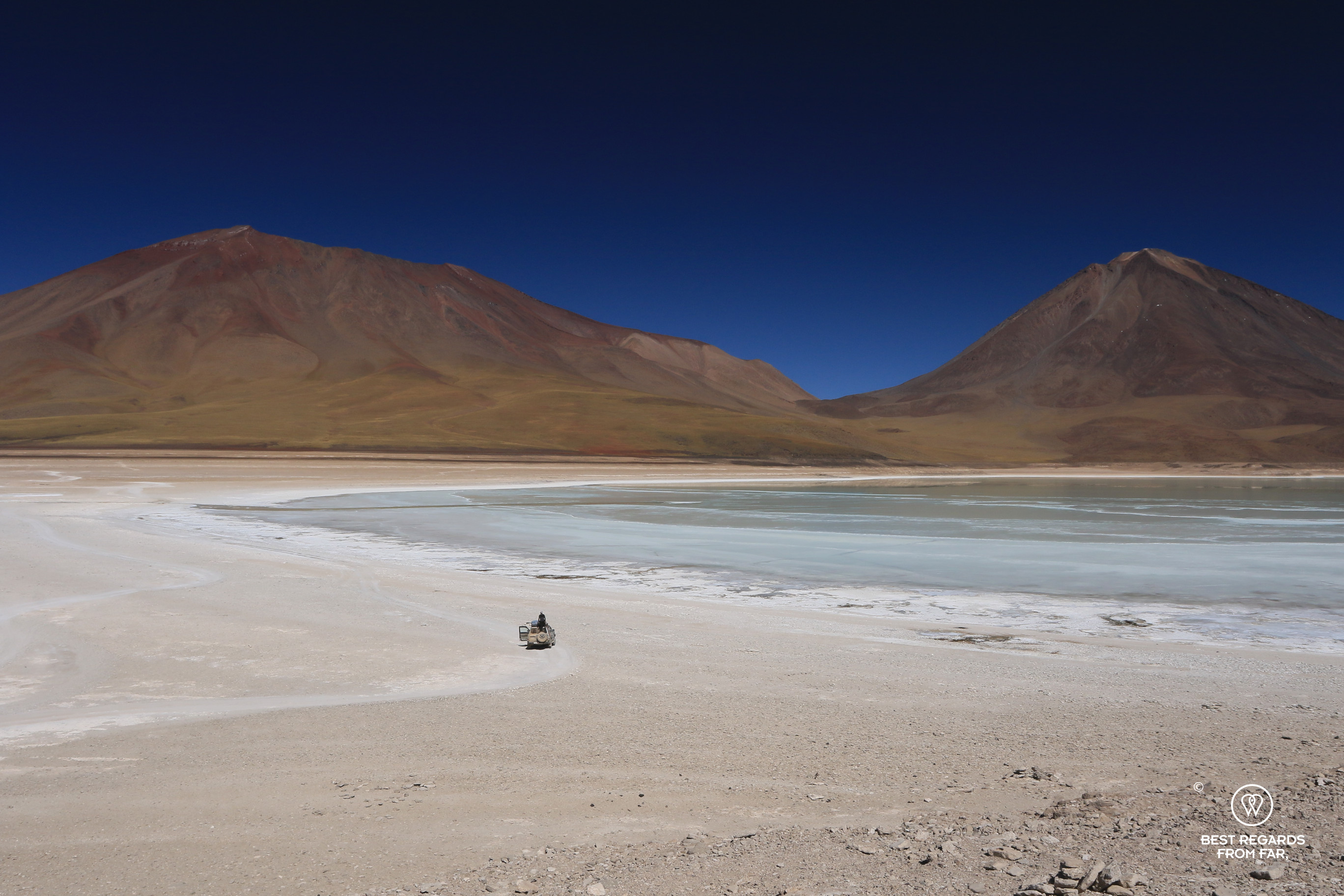 4x4 on the bank of Laguna Verde with Licancabur Volcano in the background, Bolivia.