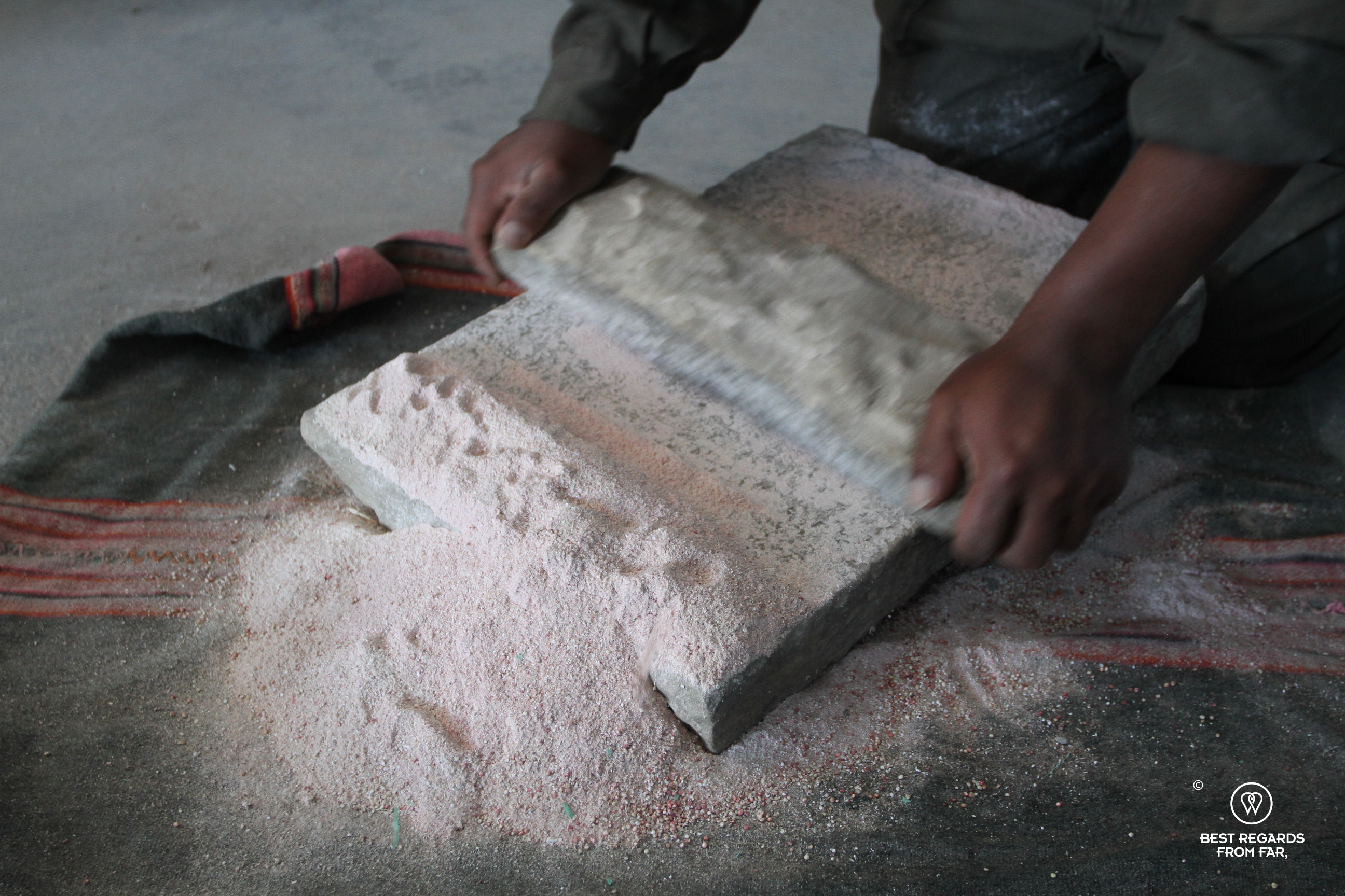 Grounding quinoa at the San Juan Quinoa museum in Bolivia.