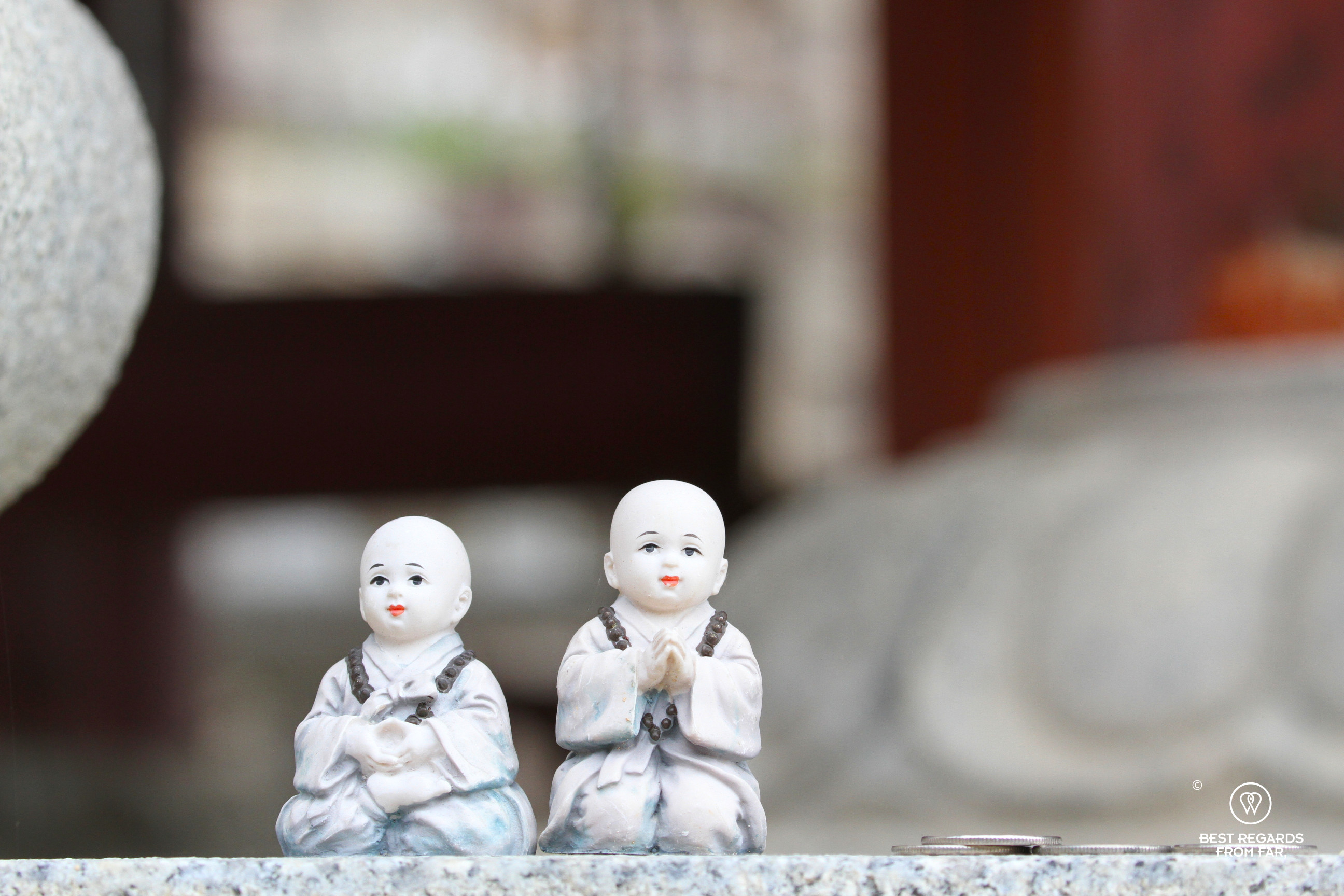 Detail of two small monk figurines at HwaeomSa temple in South Korea.