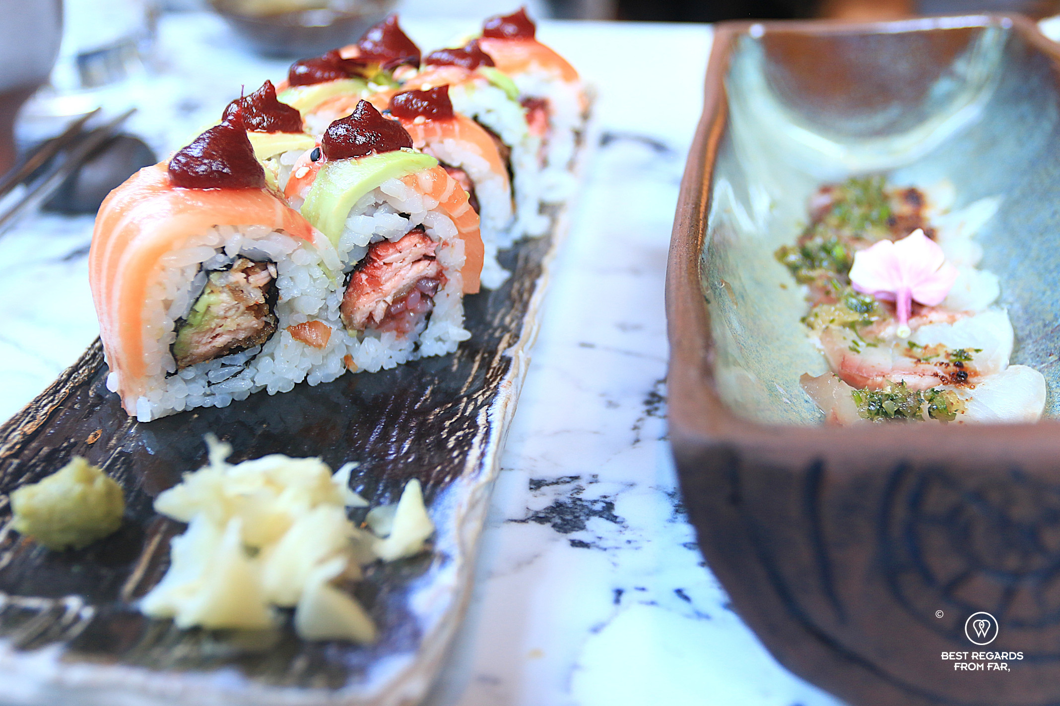Close up of elegant salmon sushis on a marble table at Nikkei restaurant in Cape Town.