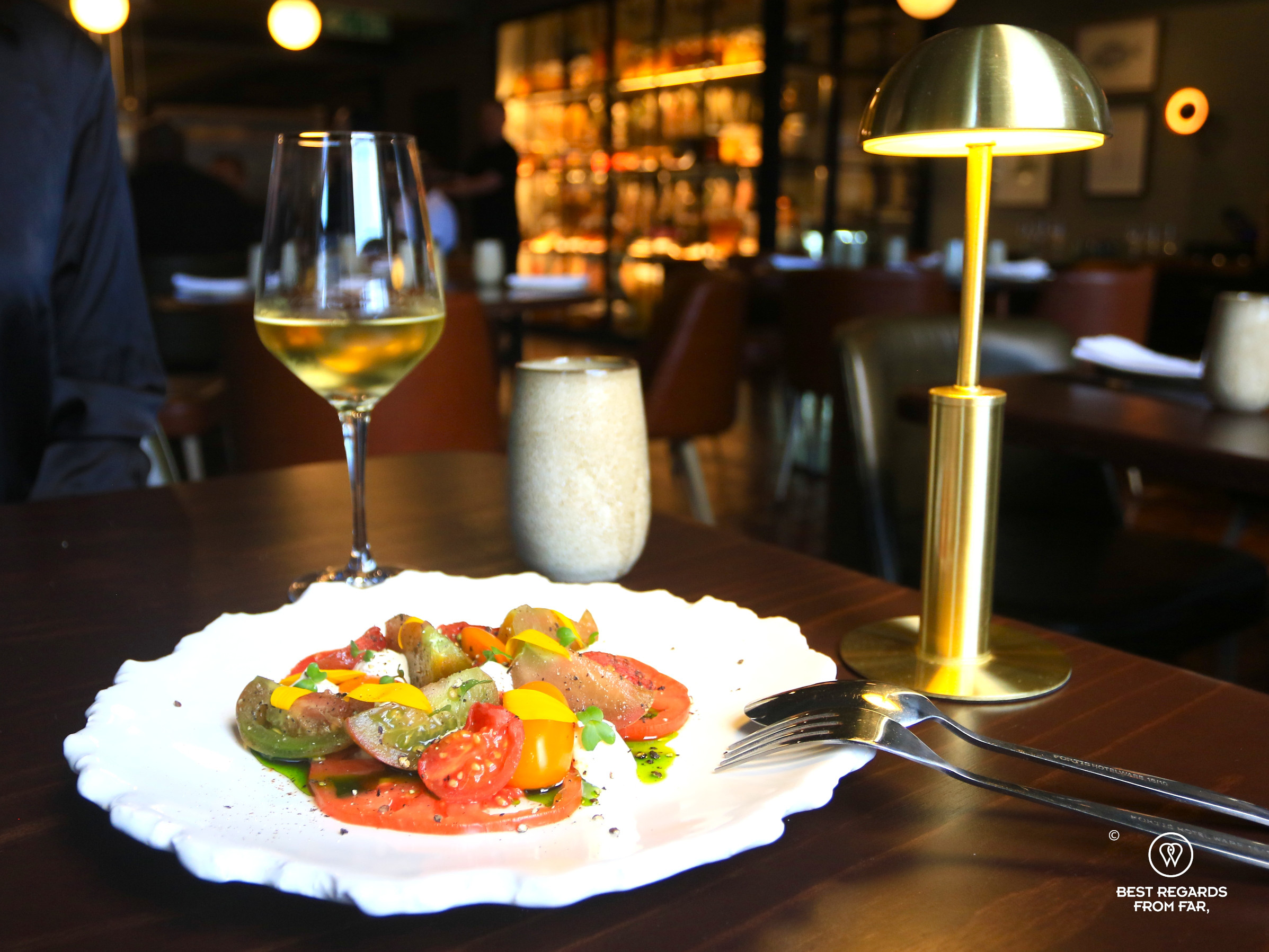 Heirloom tomato with a chilled glass of white wine at the Merchant restaurant in Cape Town.