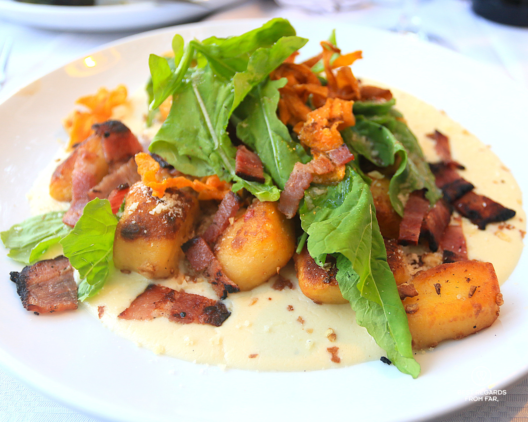 Homemade gnocchis topped off with rucola and bacon bits at Café Paradiso restaurant in Cape Town.