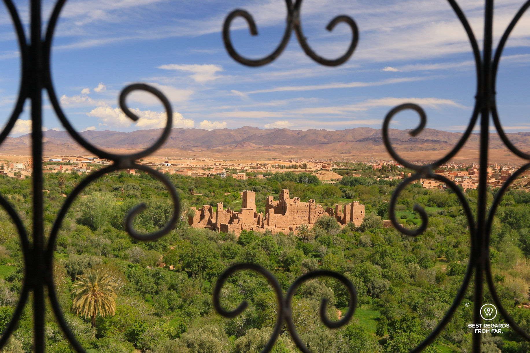 Kasbah amongst green gardens by Kalaat M'Gouna in the Valley of the Roses in Morocco.
