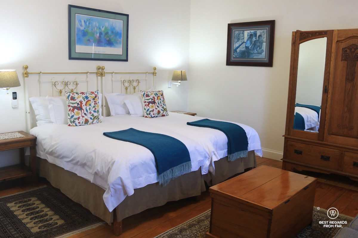 King-size bed in a room at the Altes Landhaus Lodge in Oudtshoorn in South Africa.