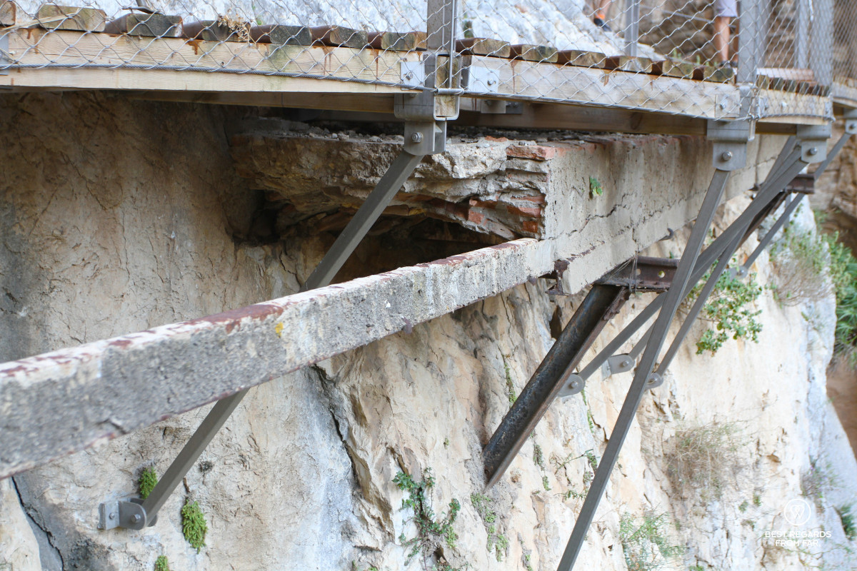 Close up of the old and new pathway of Caminito del Rey bolted into a cliff.