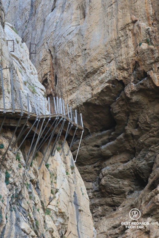Old path and new boardwalk of Caminito del Rey bolted into sheer cliffs of a canyon.