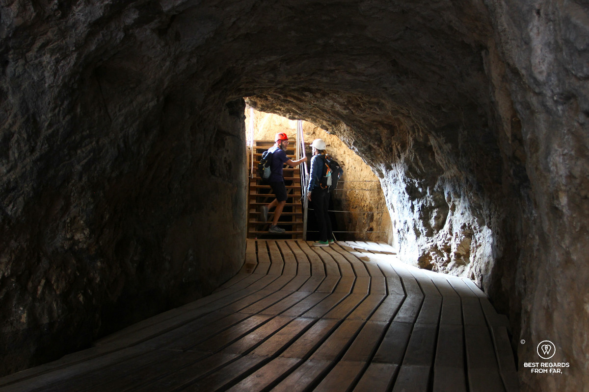 A guide and customer in one of the tunnels carved in the mountain of Caminito del Rey.