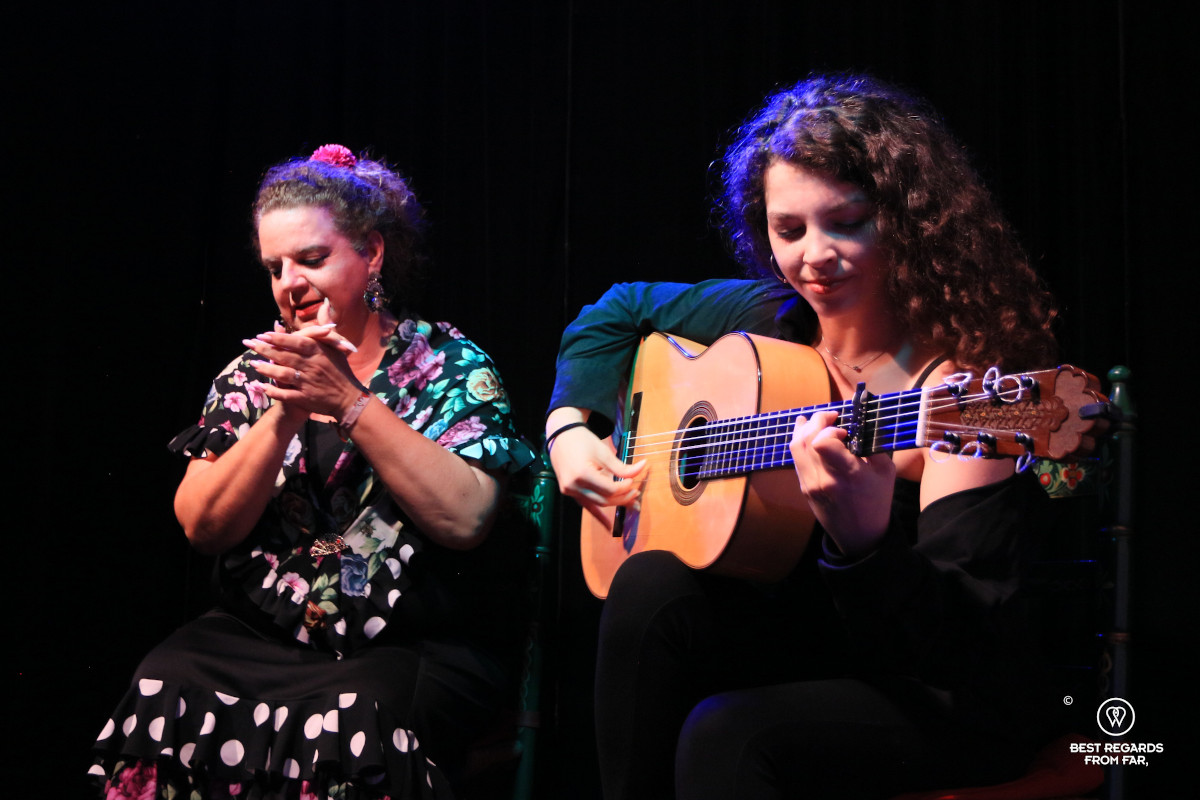 Guitarist and singer clapping in her hand at La Milonga Tablao Flamenco in Seville.