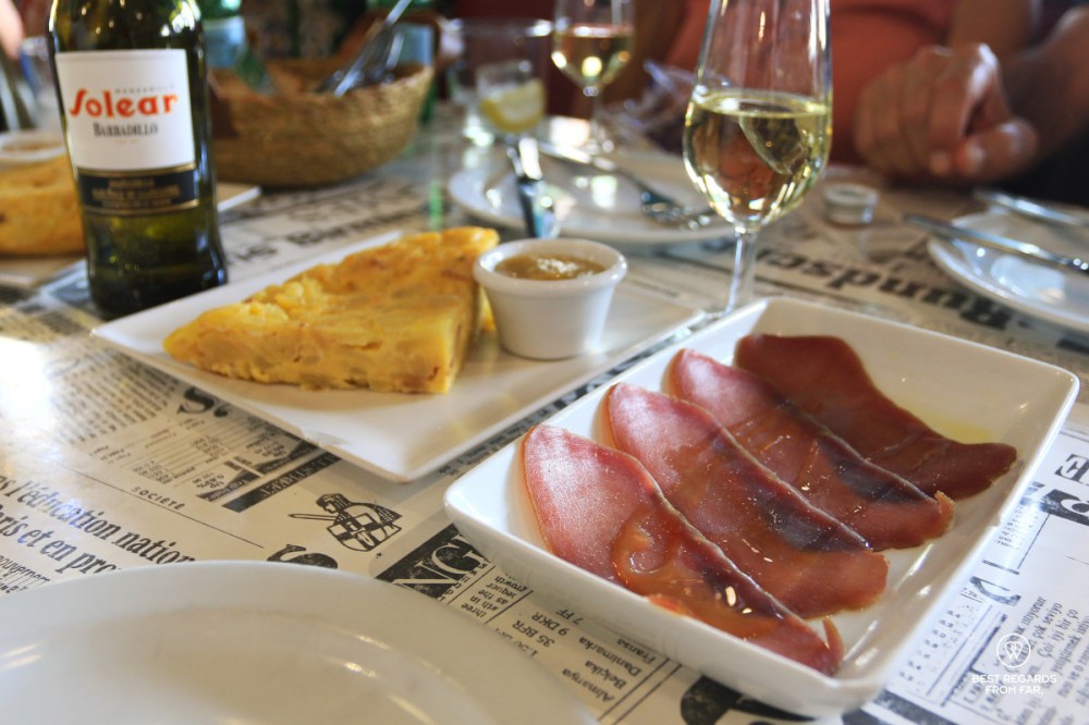 Mojama tapa and tortilla with a glass of manzanilla in Andalusia in Spain.