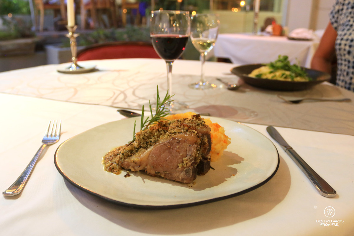 Lamb chops and hutspot, white and red wine in the background.