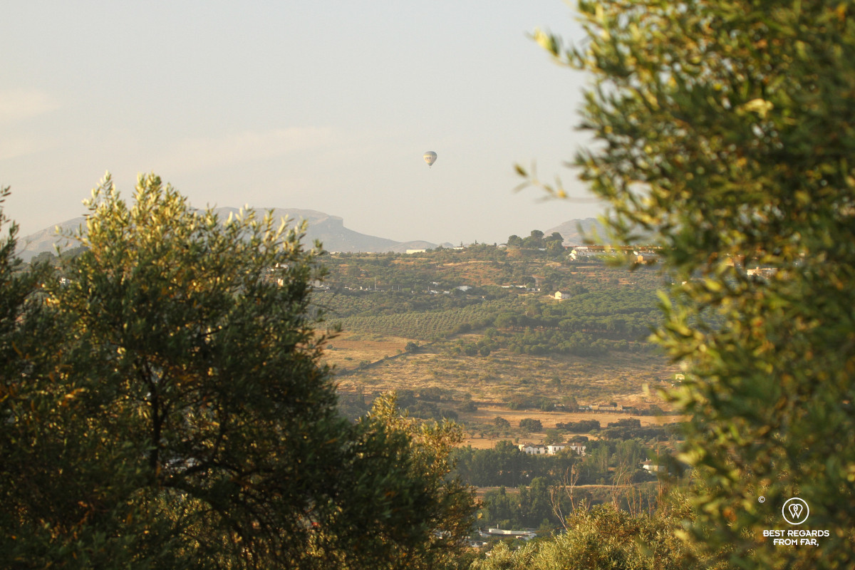 Hot air balloon above the hills of Ronda at sunrise.