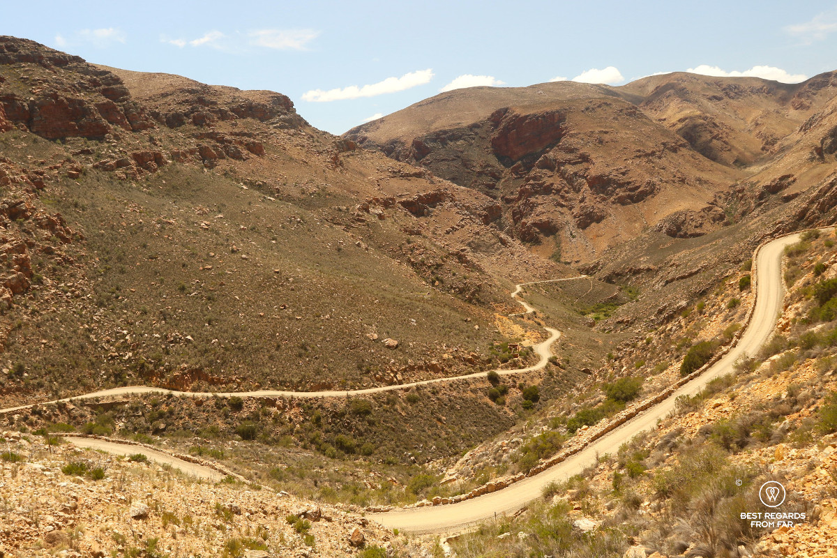 Dirt road of the Swartberg Pass in a semi-arid landscape in South Africa.