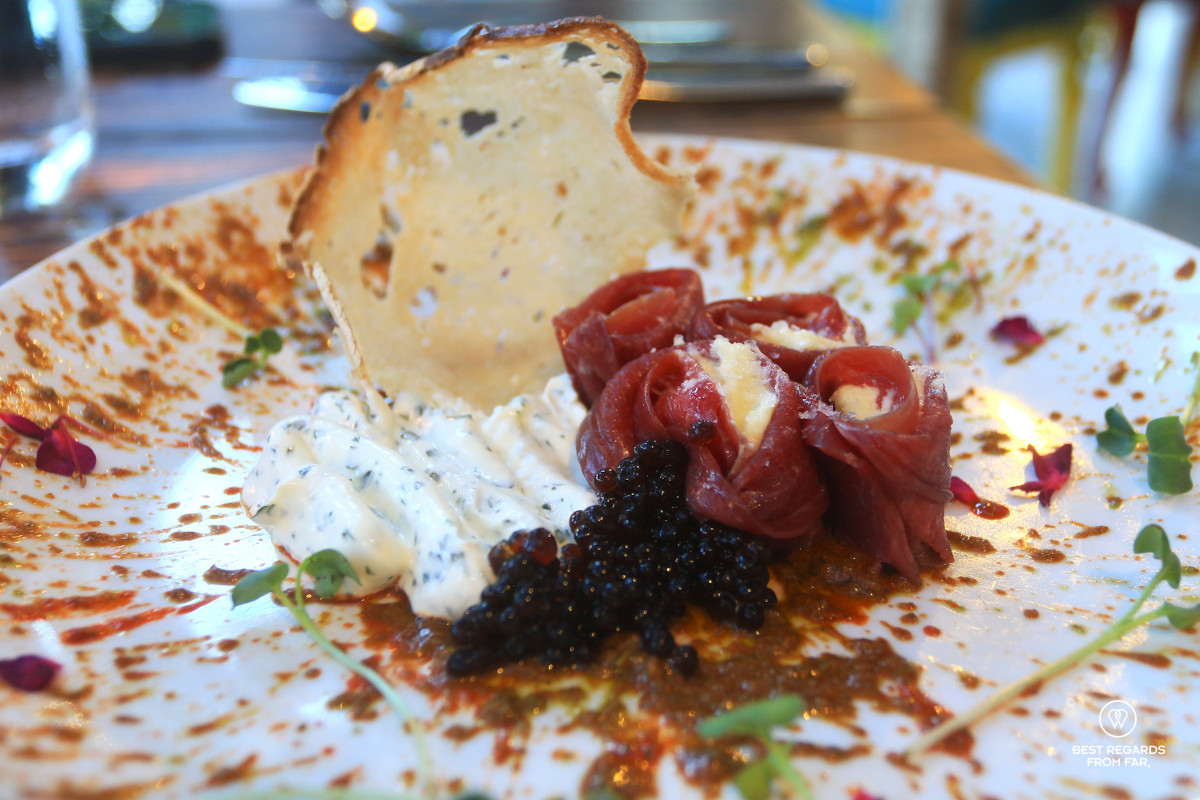 Venison carpaccio plated in a modern way with toast and caviar at the Island Café, Knysna.