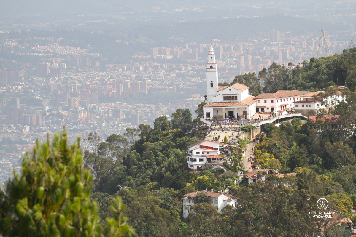 White church of Monserrate towering over the city Bogota seen from above.
