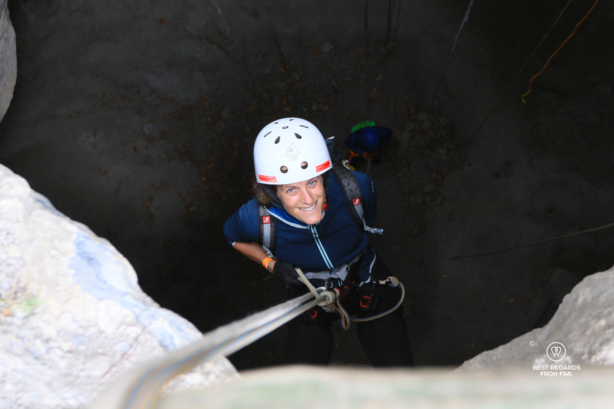 Woman rappelling into a cave.