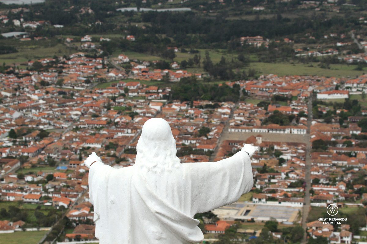 View on a colonial town from behind a Christ statue.