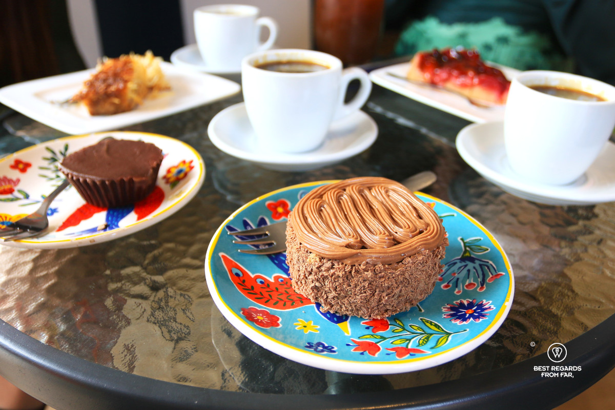 Chocolate desserts and coffee cups on a table.
