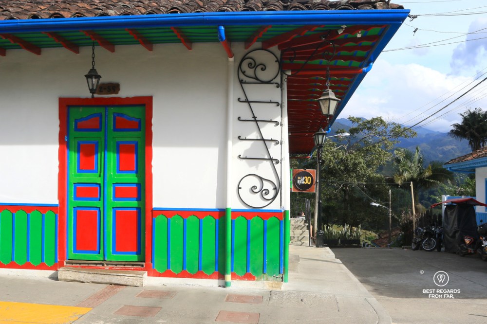 Green, blue and red paint on a white-whashed façade in Salento in Colombia.