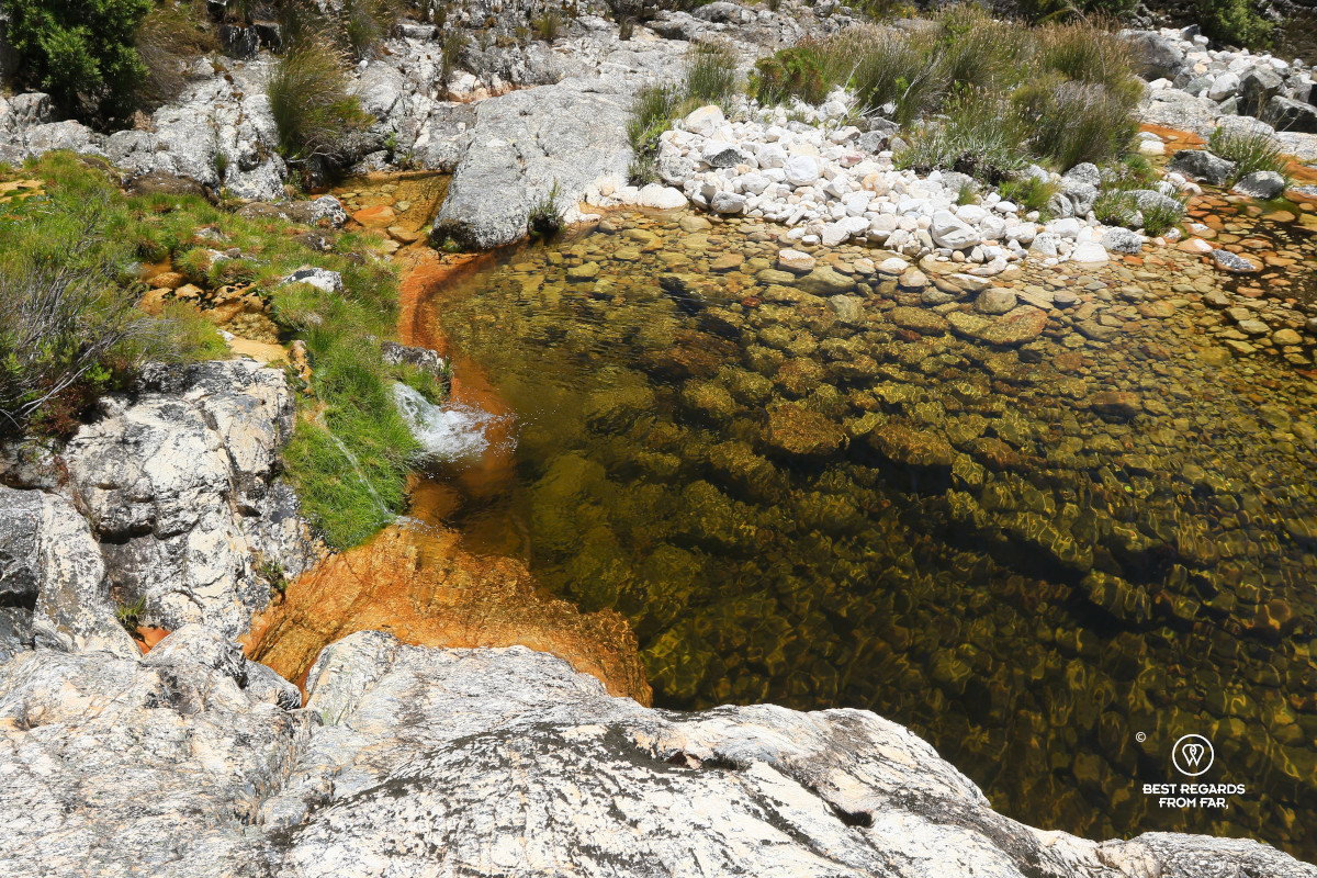 A small waterfall falling into a crystal pool on Bobbejaans River in South Africa.